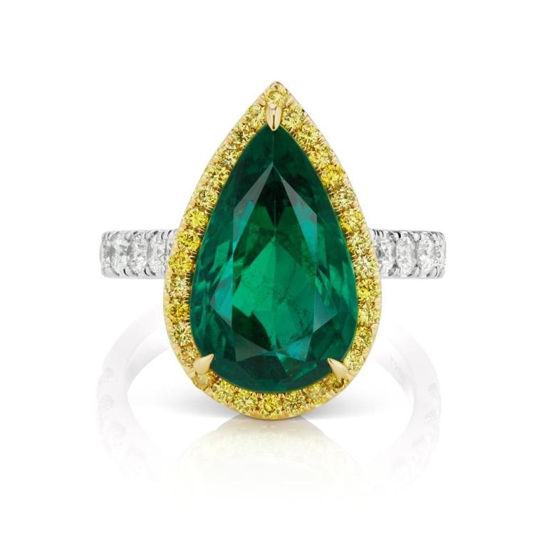 EMERALD AND DIAMOND RING A splendid 5 ct. Pear Shaped Emerald surrounded by a rich halo of yellow diamonds. A classic color combination in a contemporary styling Item: # 03213 Metal: 18k W / Y Color Weight: 5.68 ct. Diamond Weight: 1.48 ct.
