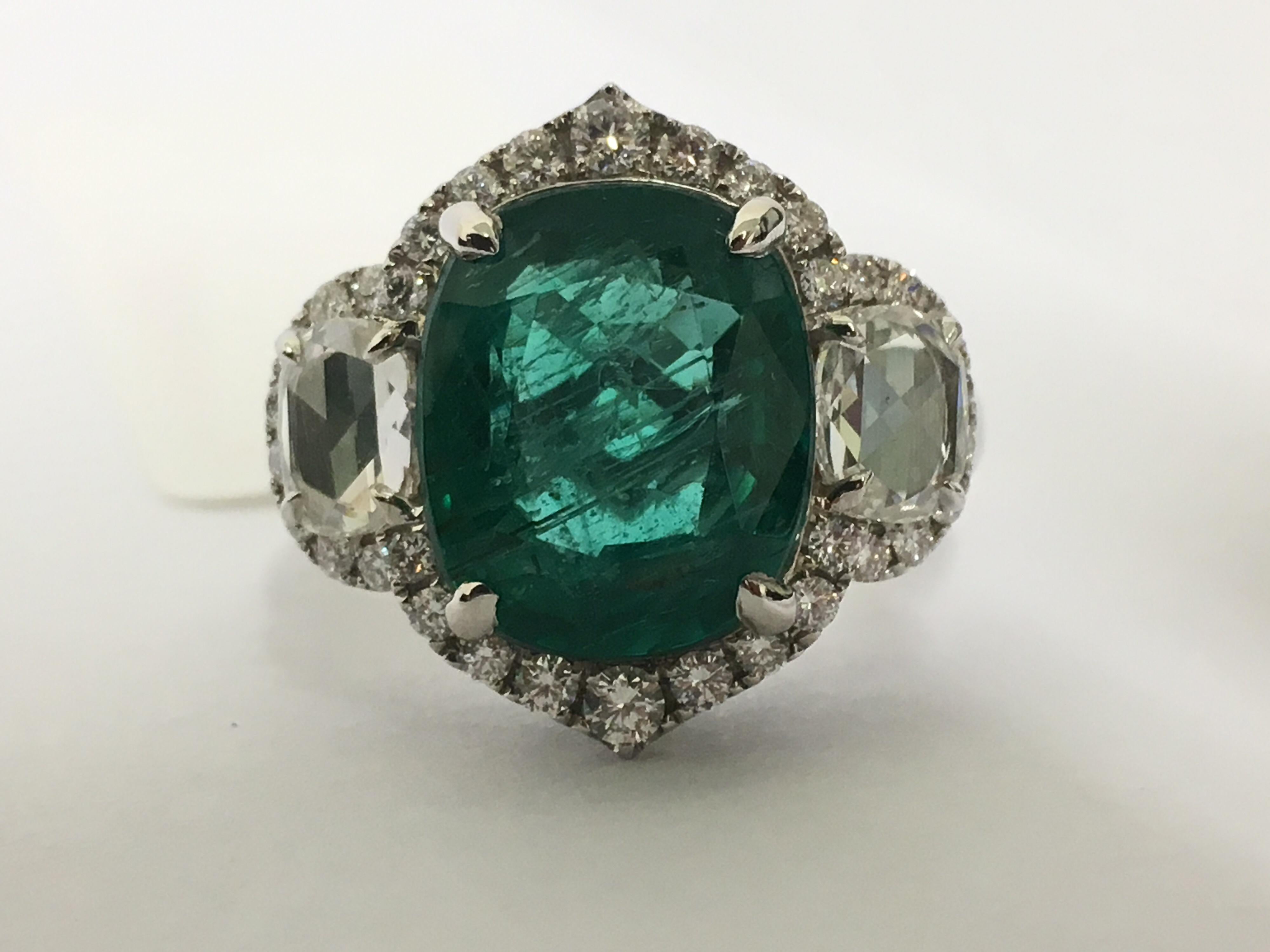 Natural Cushion cut 4.70 Carat Emerald with 1.17 Carat full cut and rose cut Diamonds set in 18 Karat white gold is one of a kind handcrafted Ring. The Emerald is 100 % Natural no heat treat or color enhanced or any kind of treatment is done.The