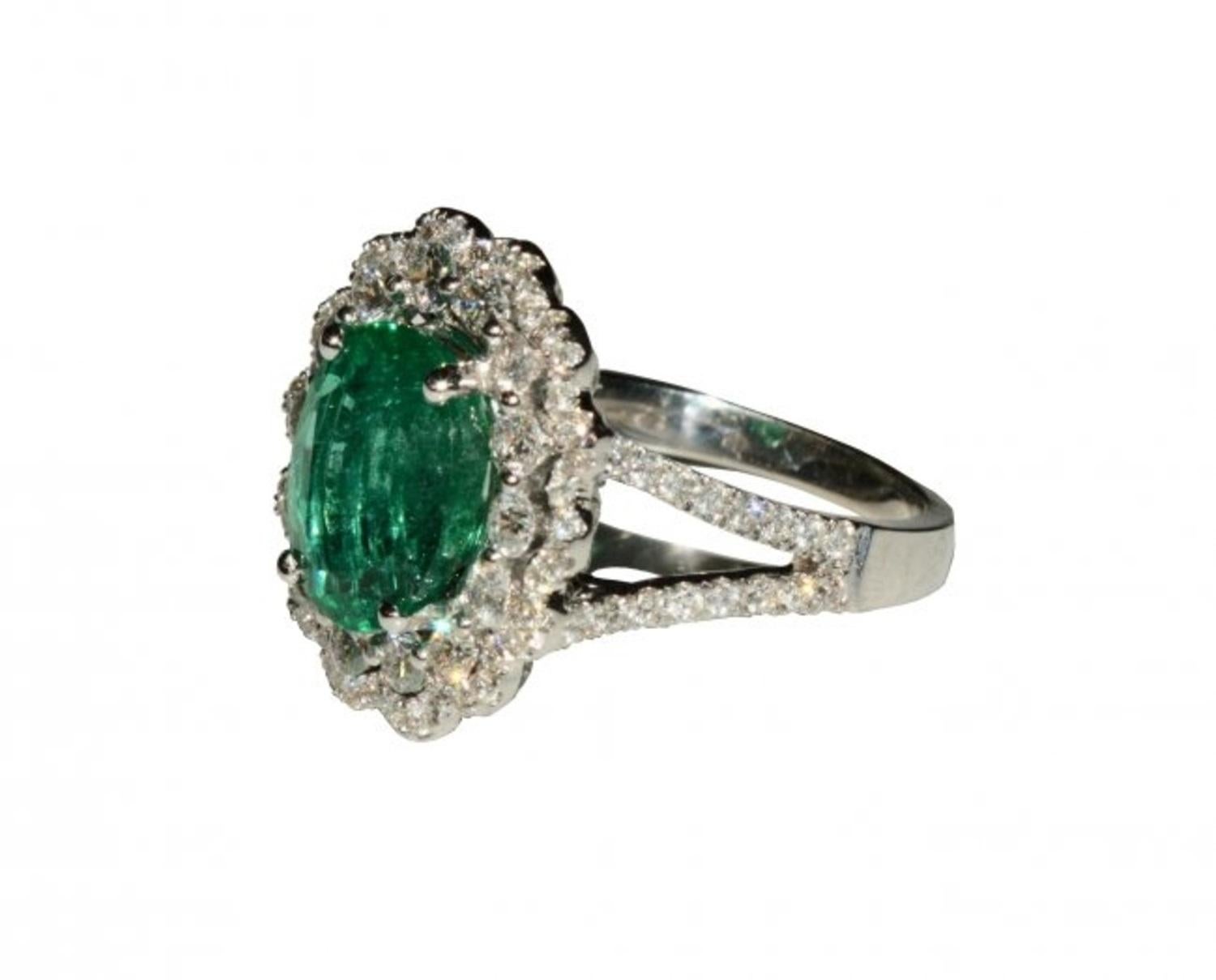 Emerald and Diamond Ring, centered by an oval cut Emerald weighing approximately 3.52 cts, surrounded by diamonds weighing approximately .85 cts 
Mounted in 18kt white gold 
6.2 grams (gross) 
Size 6 3/4