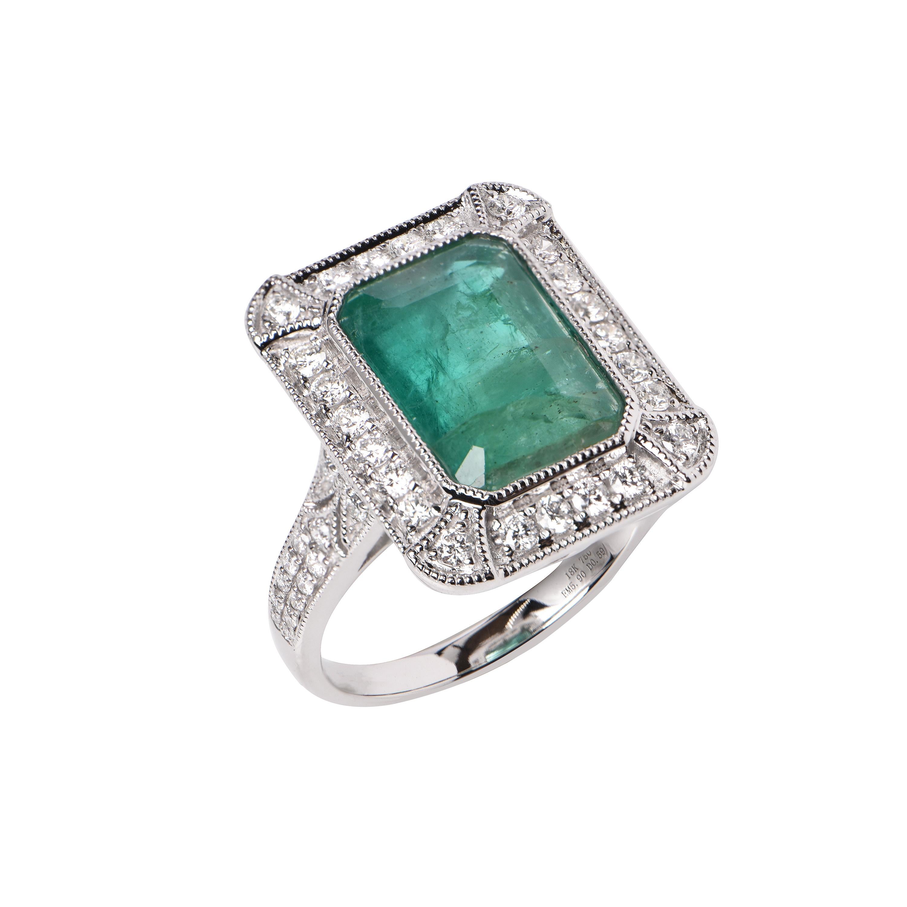 An 18ct White Gold ring showcasing an Emerald (5.90ct), and 50 Diamonds totalling 0.59ct.
