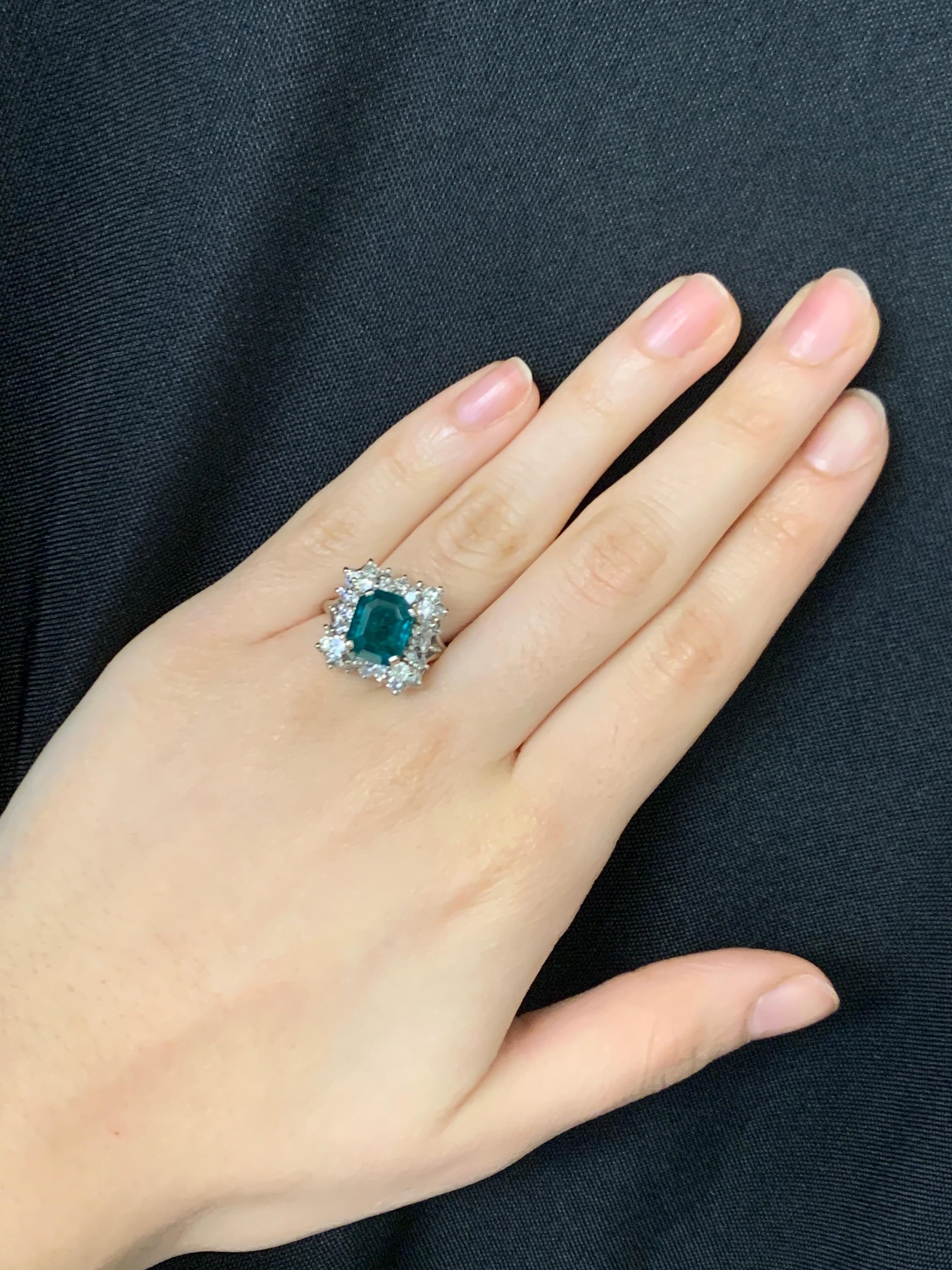 Emerald and Diamond Ring 

A white gold ring set with a central emerald framed by round-cut diamonds

Emerald Approximate Weight: 3.05 carats

Total Approximate Diamond Weight: 2.16 carats

Ring Size: 6.5

Resizable free of charge

Metal Type: 14