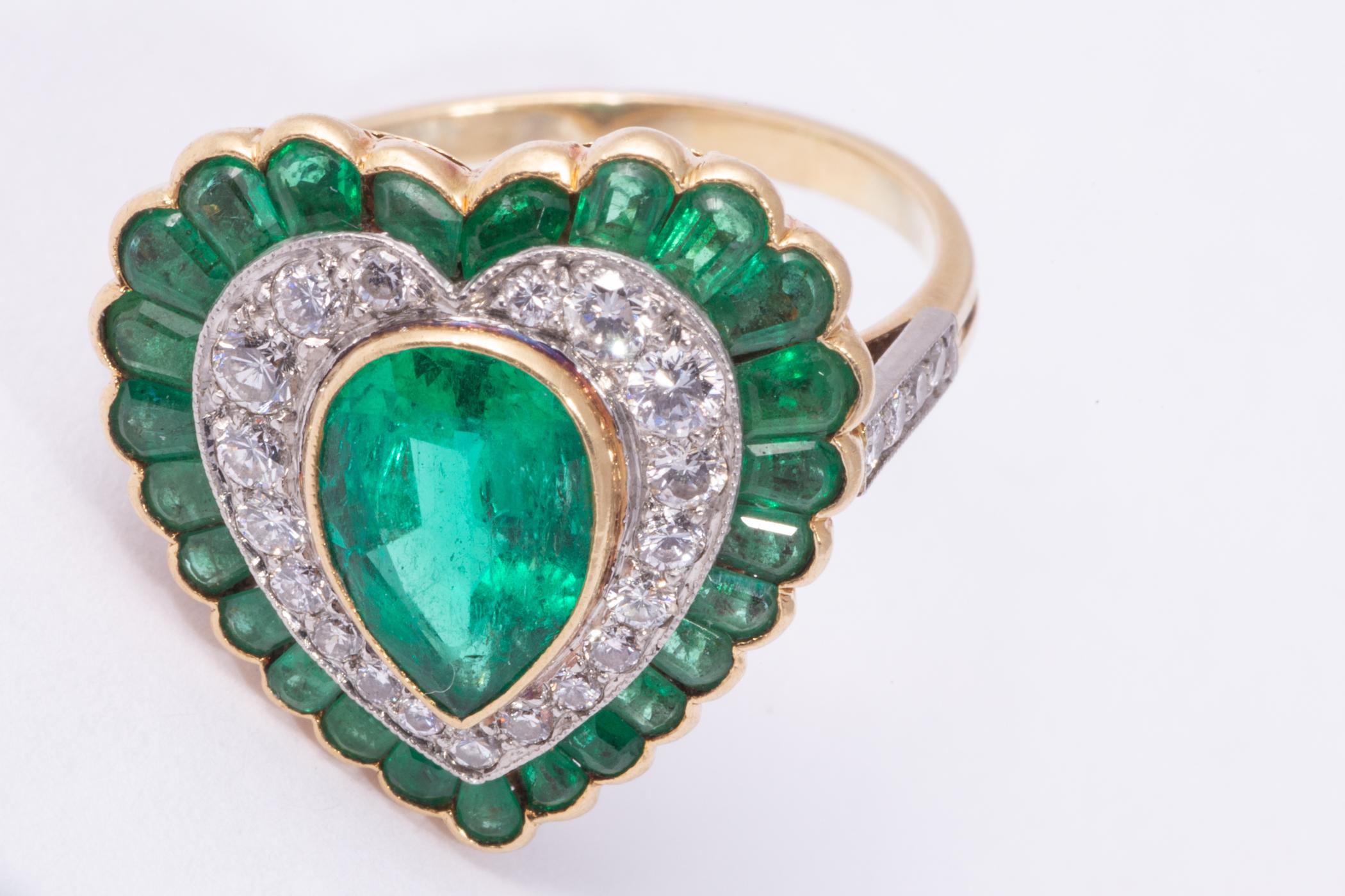 Wonderful heart shaped ring featuring a pear shape cut emerald weighing approx.2.00cts The emerald has excellent color and transparent clarity, it's a very livley emerald!. There are 19 diamonds weighing approx. .80cts and having F-G, and VS clarity