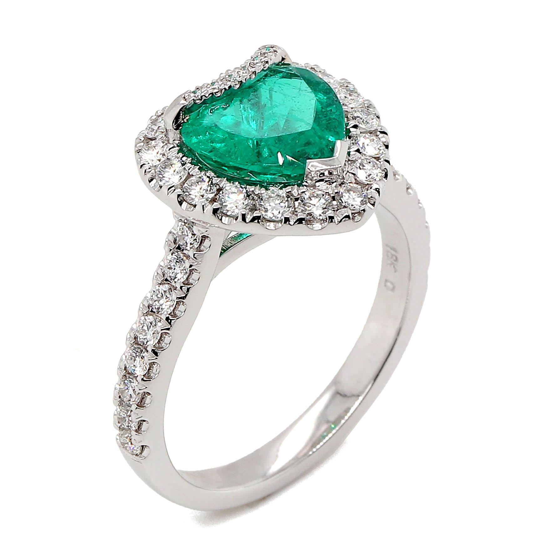 GIA very fine heart shape Emerald of about 1.46 carats measuring 7.96×8.06×4.35mm. The Emerald is surrounded by 40 round brilliant cut diamonds of about 0.55 carats with a clarity of VS and color G. All stones are set in 18k white gold. The total