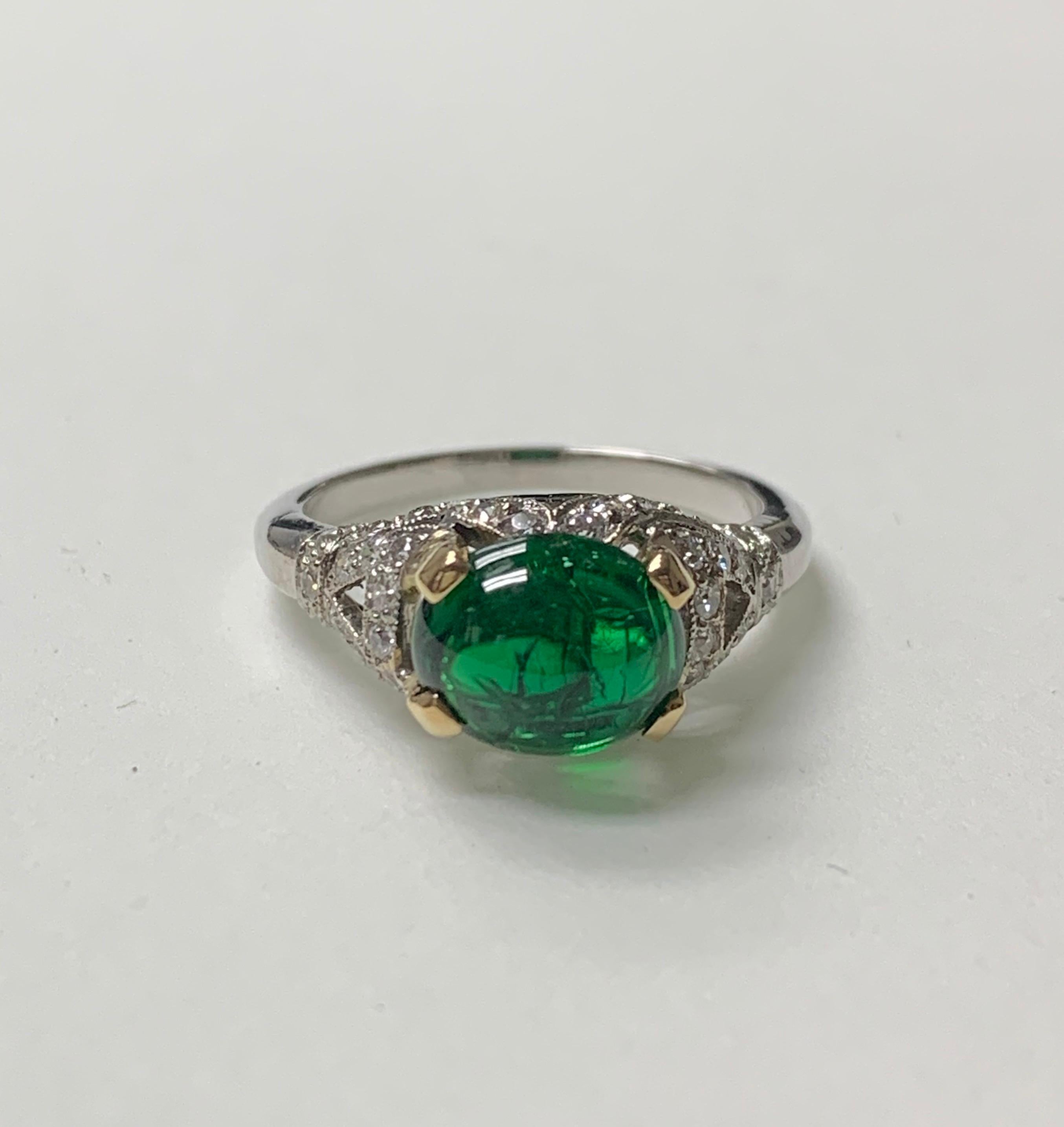 This very pretty cabochon emerald and diamond ring is hand crafted in 18k white gold. 
The details are as follows : 
Emerald weight : 
Diamond weight : 0.50 carat 
Metal : 18 K white gold 
Ring size : 7