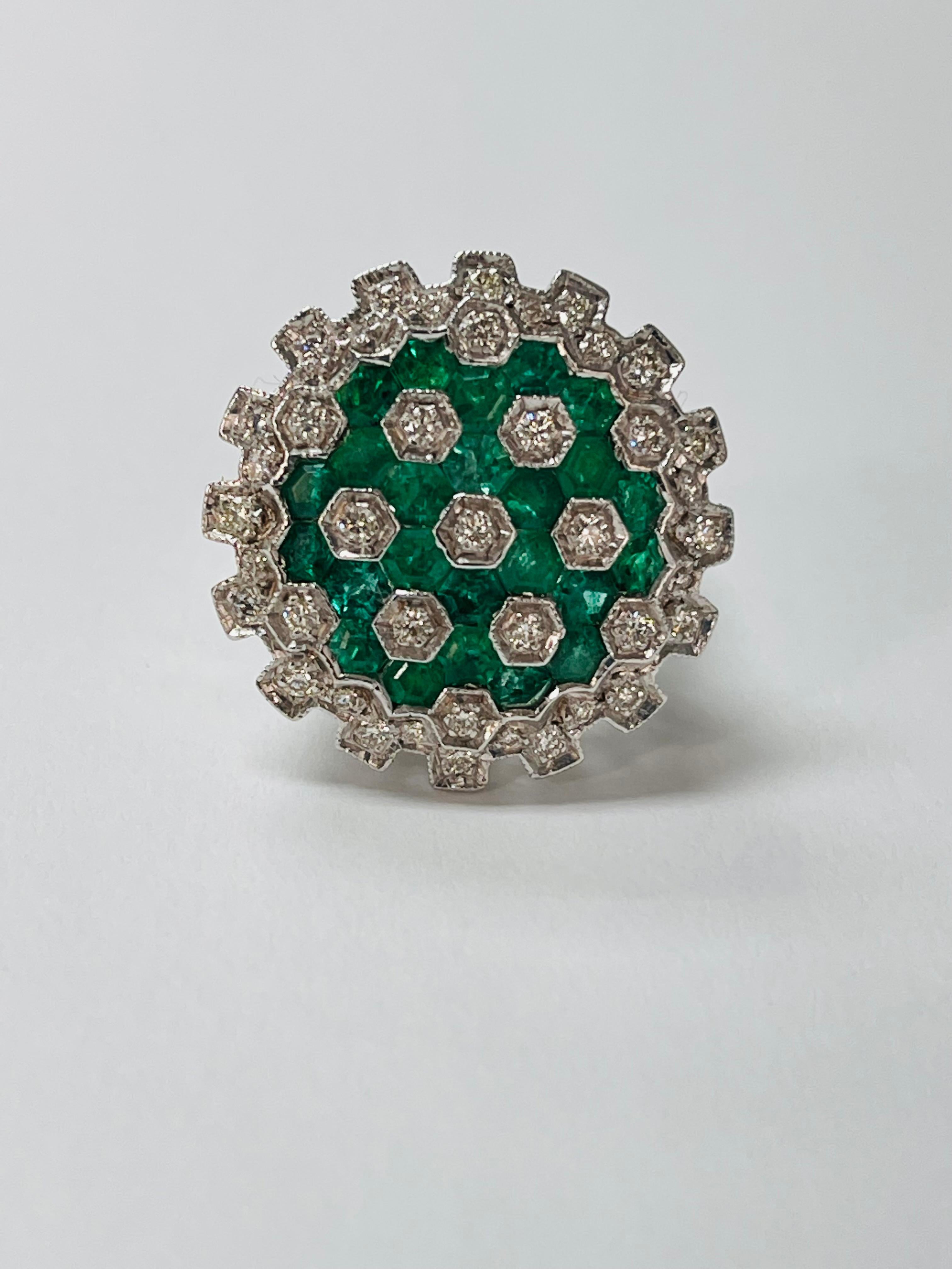 Emerald and diamond ring handcrafted in 18k white gold. 
The details are as follows : 
Diamond weight : 0.66 carat ( GH color and VS clarity ) 
Metal : 18k white gold 
Gold Weight: 10.1 grams 

