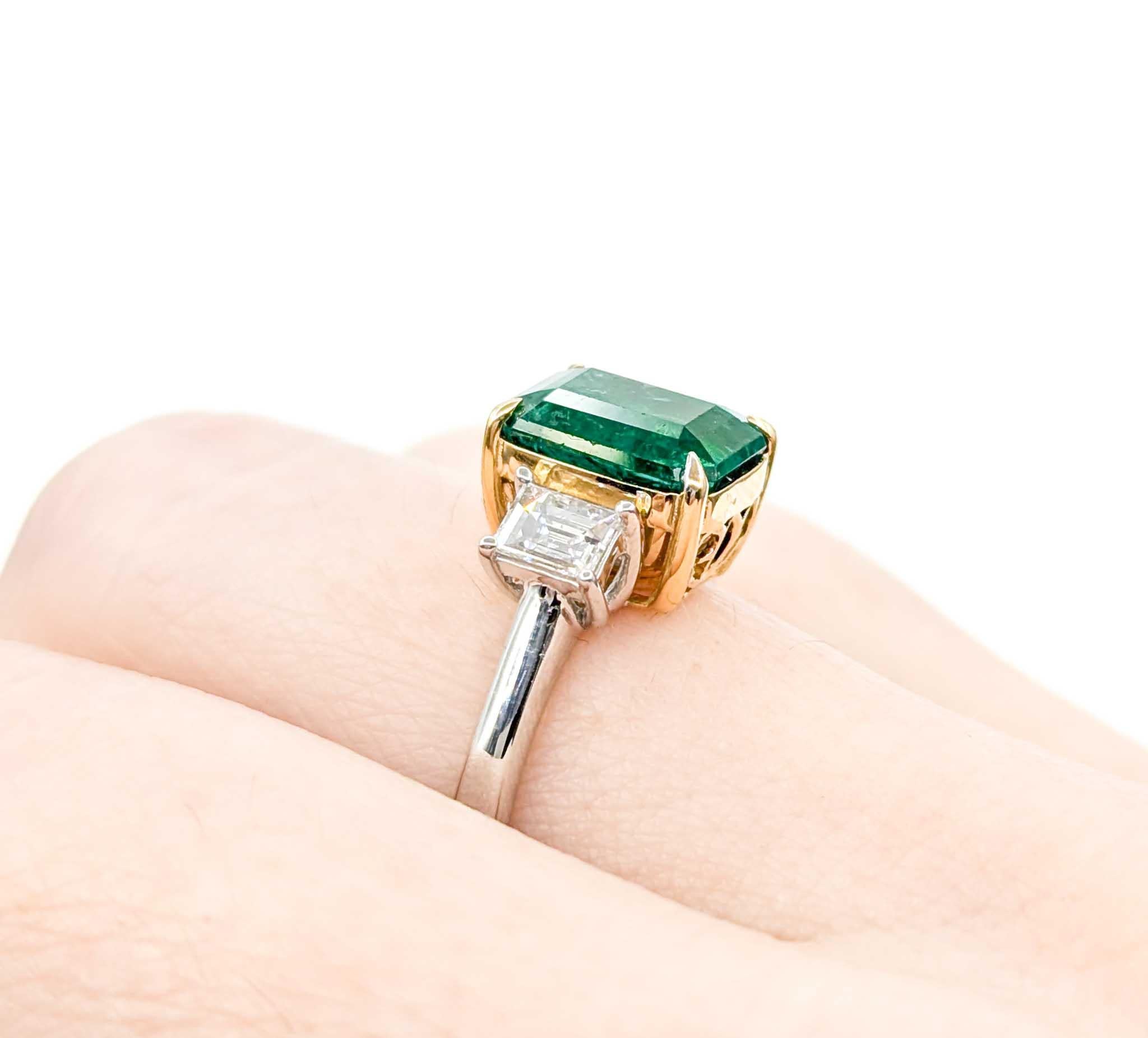 Elegant Emerald and Diamond Ring in Platinum/18k Yellow Gold

Introducing this beautiful emerald ring, crafted in platinum and 18k yellow gold. The ring features a 2.59ct emerald centerpiece with .48ctw emerald cut diamonds and a three-stone design,