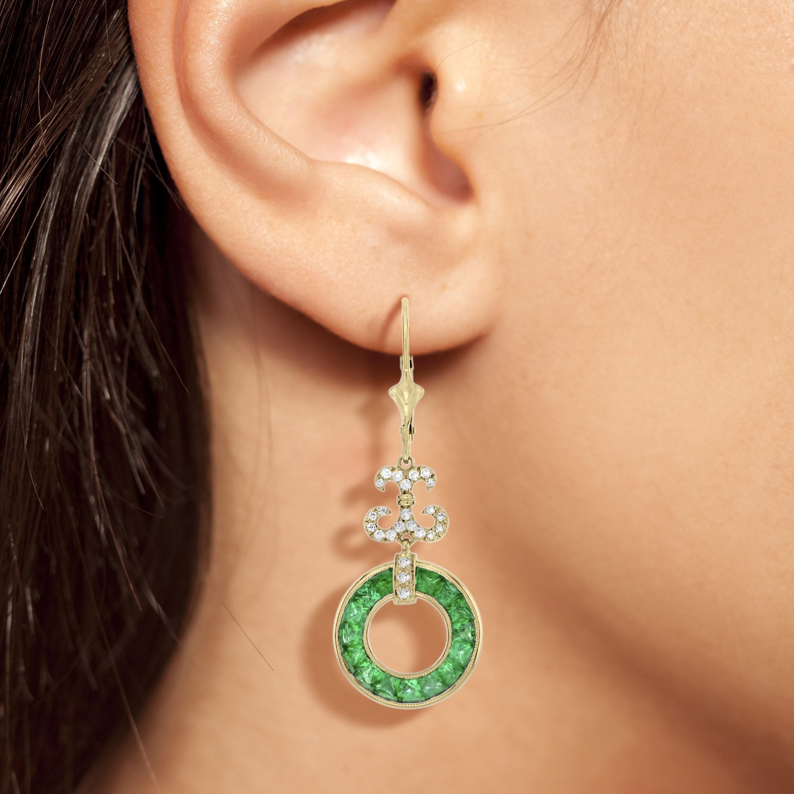 A pair of Art Deco style emerald and diamond drop earrings, set with round French cut emerald open circle suspended from a row of round diamond. A really useful everyday ear stud that you will fall in love with. 

Information
Style: Art Deco
Metal: