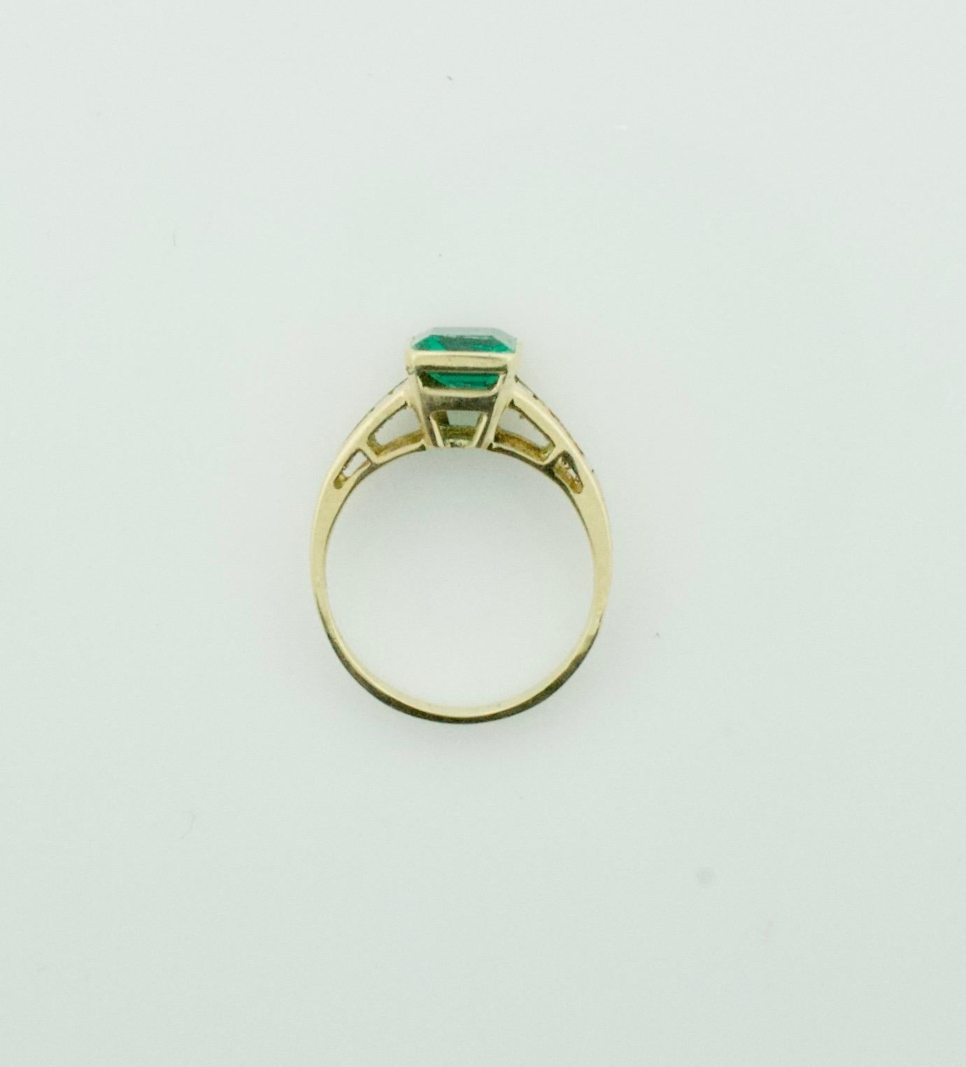 Emerald and Diamond Solitaire Ring in 18k Yellow Gold
One emerald Cut Emerald Weighing 1.24 Carats  [bright with no imperfections visible to the naked eye]
Ten Baguette Cut Diamonds Weighing .53 Carats Approximately
Set In 18k Yellow Gold
Purchased