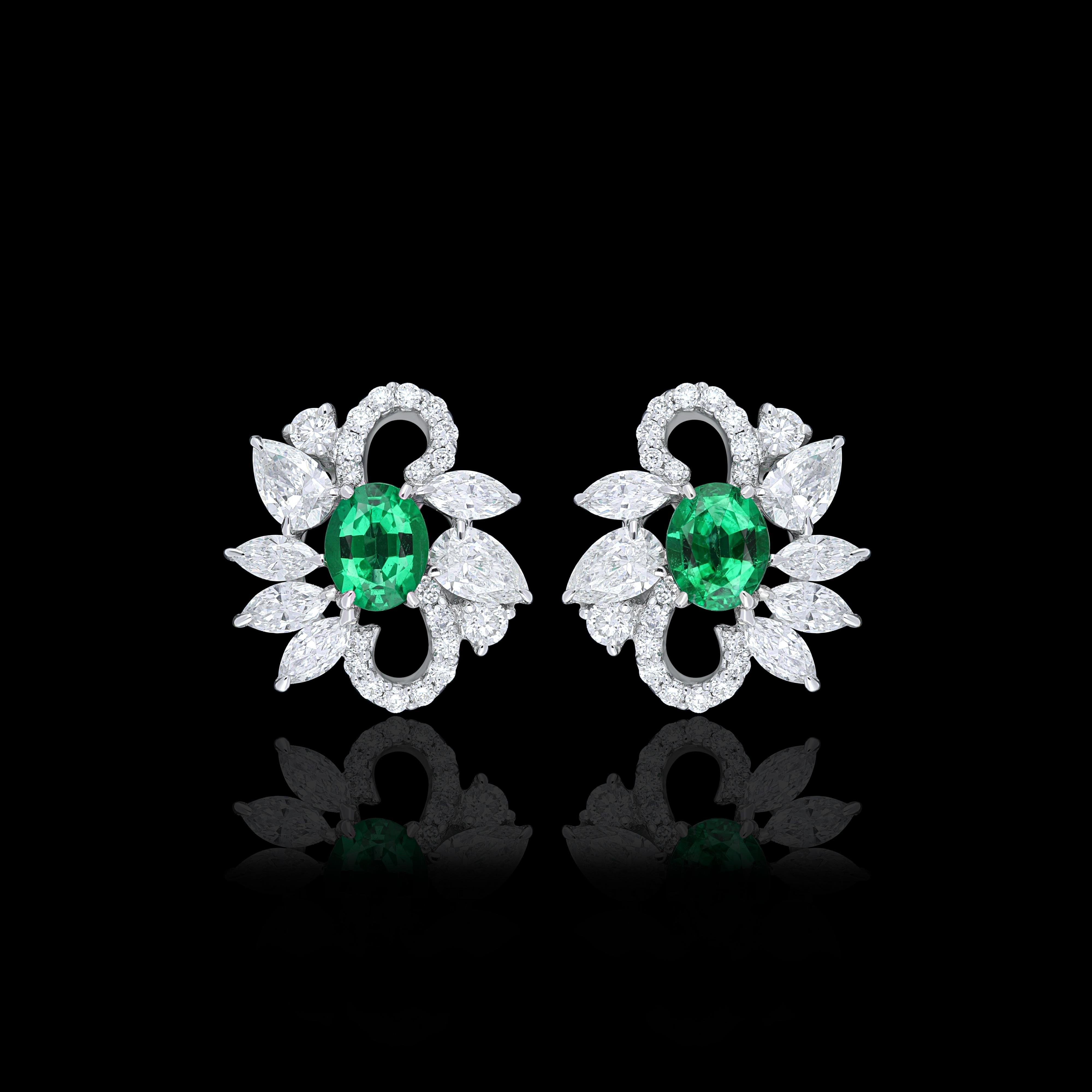Elegant and exquisitely detailed 18 Karat White Gold Earring, center set with 0.56Cts .Oval Shape Emerald and micro pave set Diamonds, weighing approx. 1.14Cts Beautifully Hand crafted in 18 Karat White Gold.

Stone Detail:
Emerald: 5x4MM

Stone