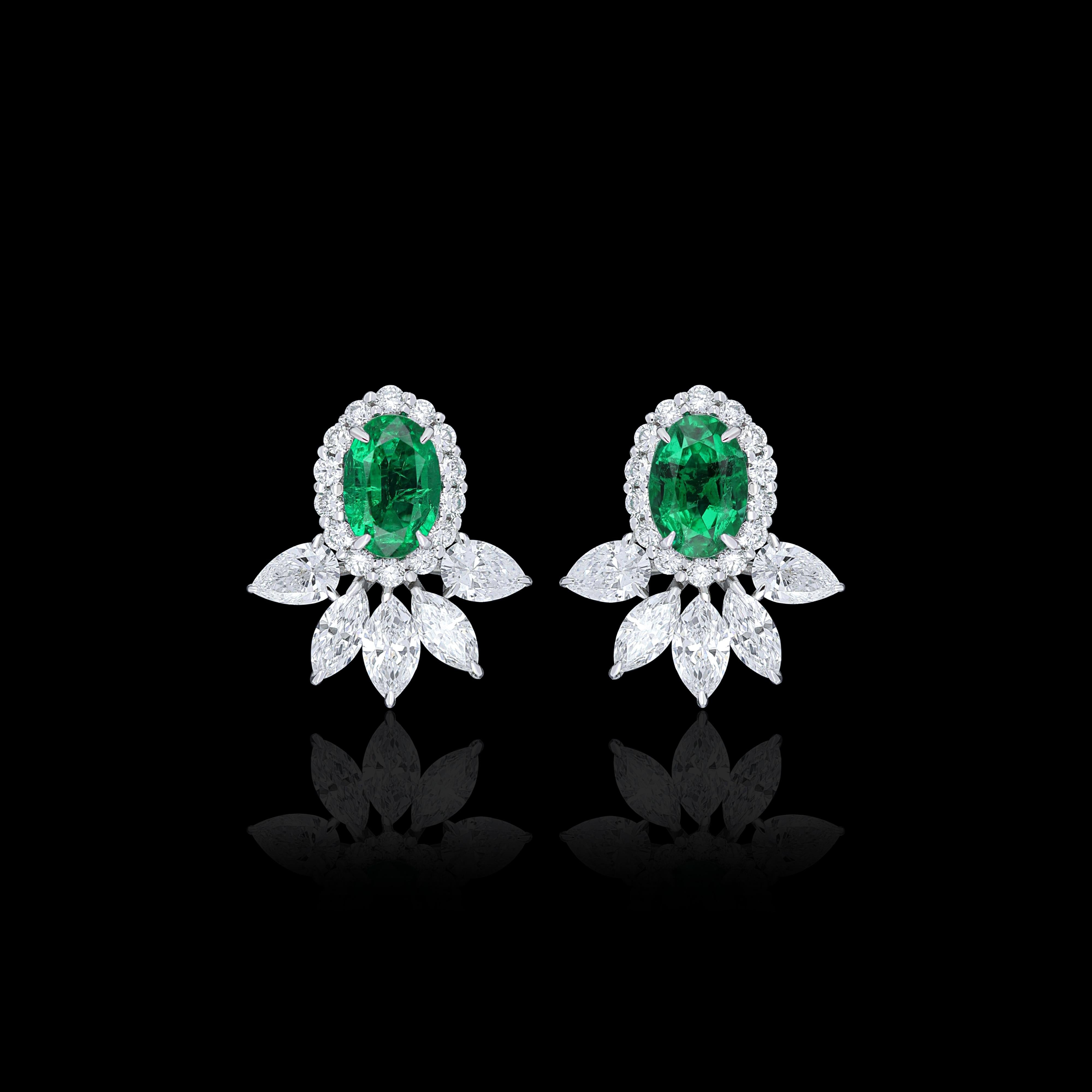 Elegant and exquisitely detailed 18 Karat White Gold Earring, centre set with 0.87Cts Oval Shape Emerald and micro pave set Diamonds, weighing approx 1.10Cts Beautifully Hand crafted in 18 Karat White Gold.

Stone Detail:
Emerald: 6x4MM

Stone