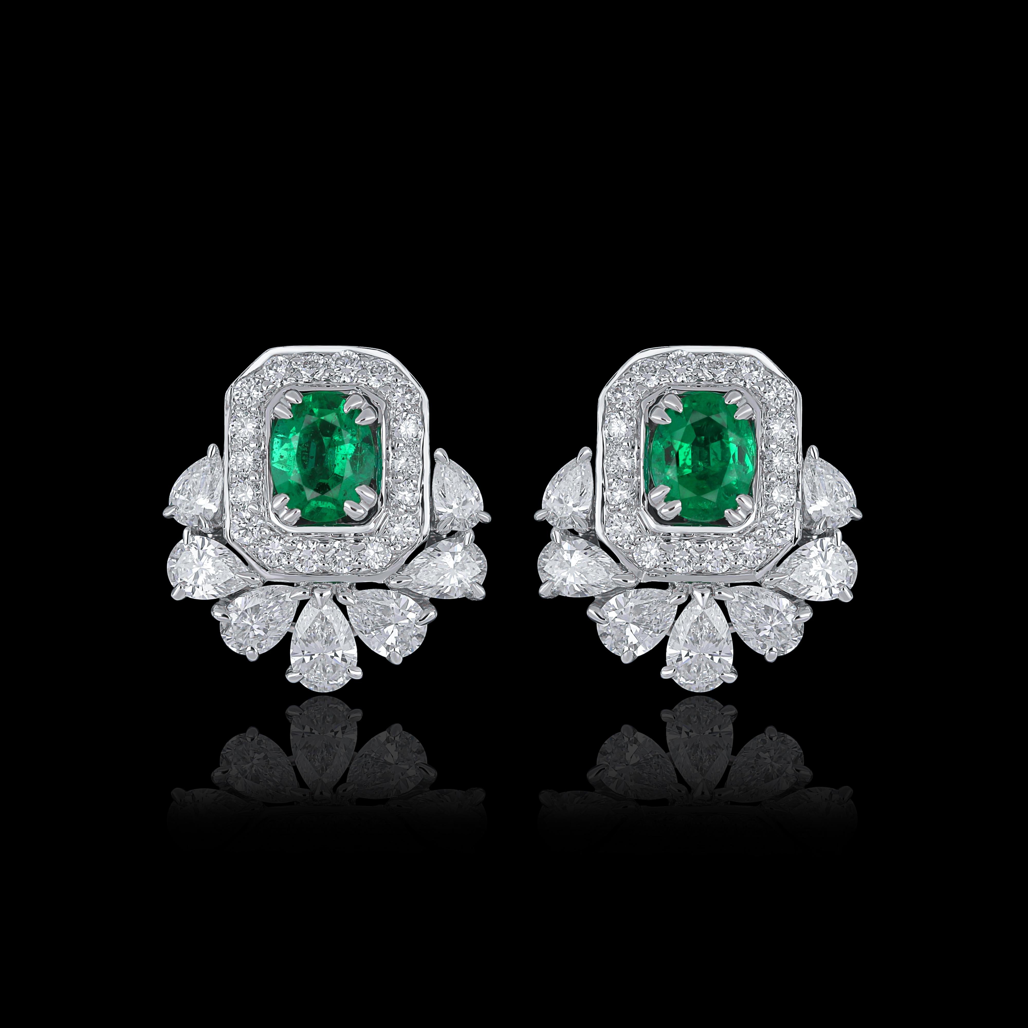 Elegant and exquisitely detailed 18 Karat White Gold Earring, center set with 0.55Cts .Oval Shape Emerald and micro pave set Diamonds, weighing approx. 1.37Cts Beautifully Hand crafted in 18 Karat White Gold.

Stone Detail:
Emerald: 5x4MM

Stone