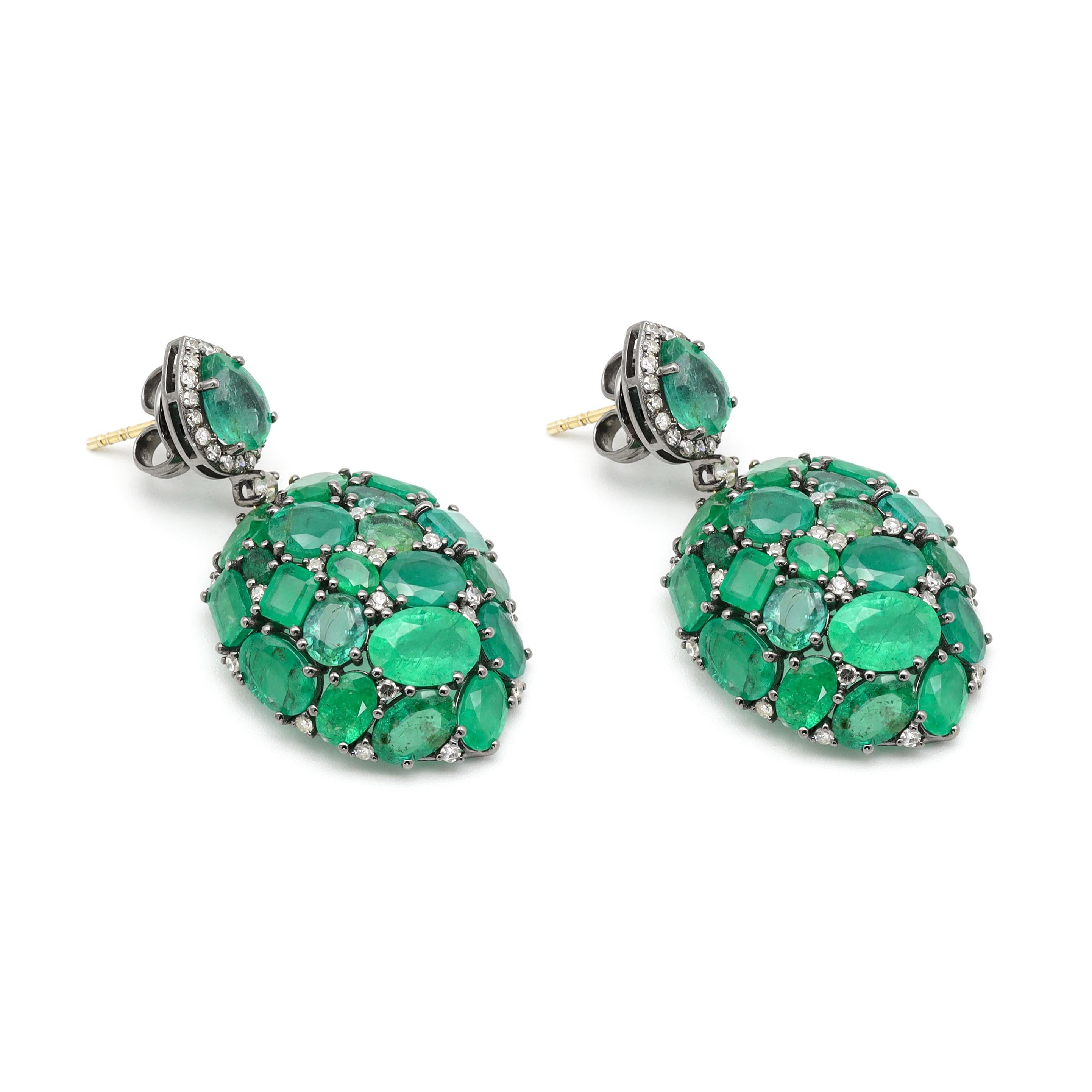 Natural Emerald and Diamond Teardrop Earrings

This Victorian-era art-deco style fascinating lush green emerald teardrop style earring is graceful. The mixed size and shape of solitaire emeralds are beautifully placed to form the domed teardrop