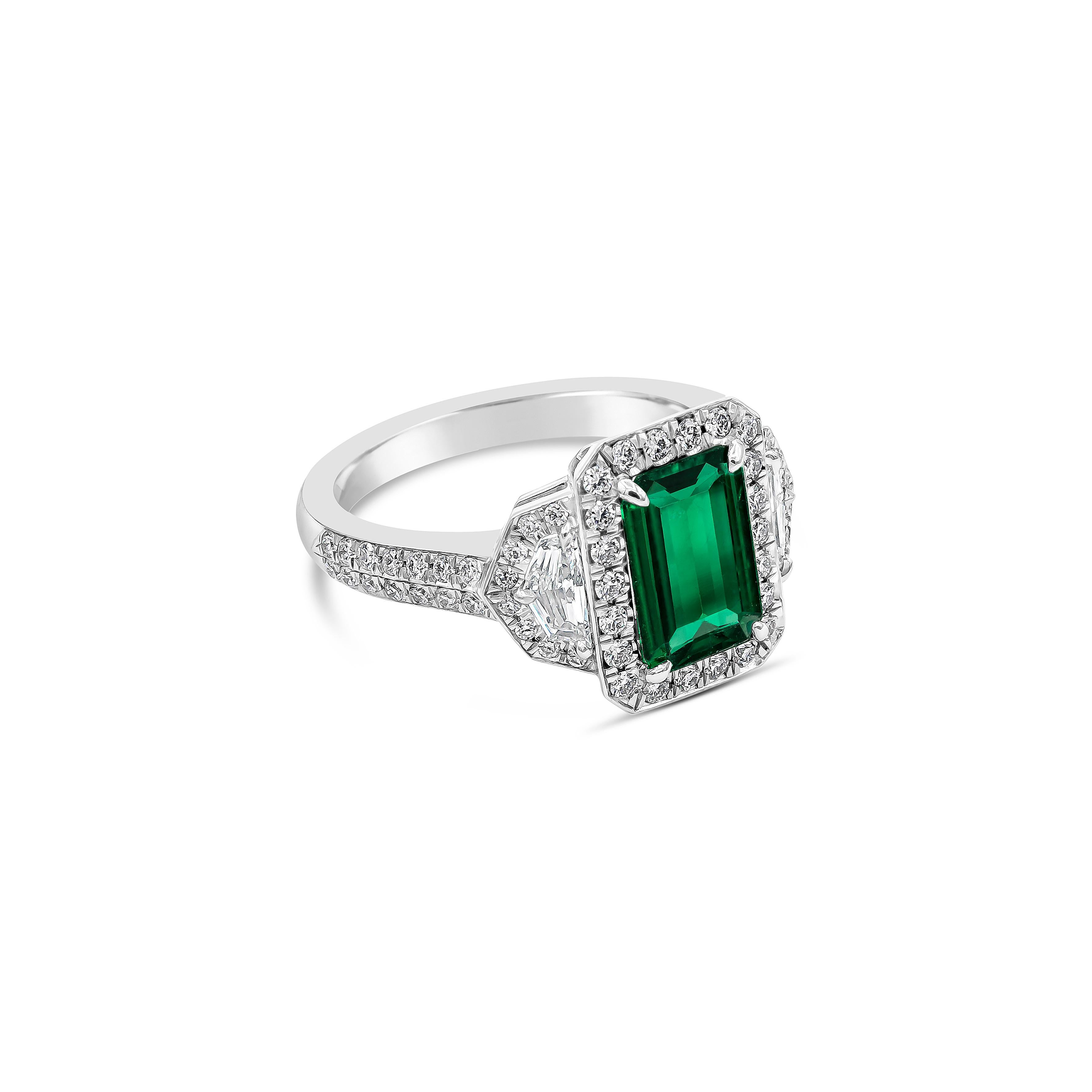Showcases an emerald cut Colombian green emerald weighing 1.16 carats, flanked by epaulette diamonds weighing 0.28 carats total. Surrounded by a single row of round diamonds on an accented platinum band. Accent diamonds weigh 0.44 carats total.

