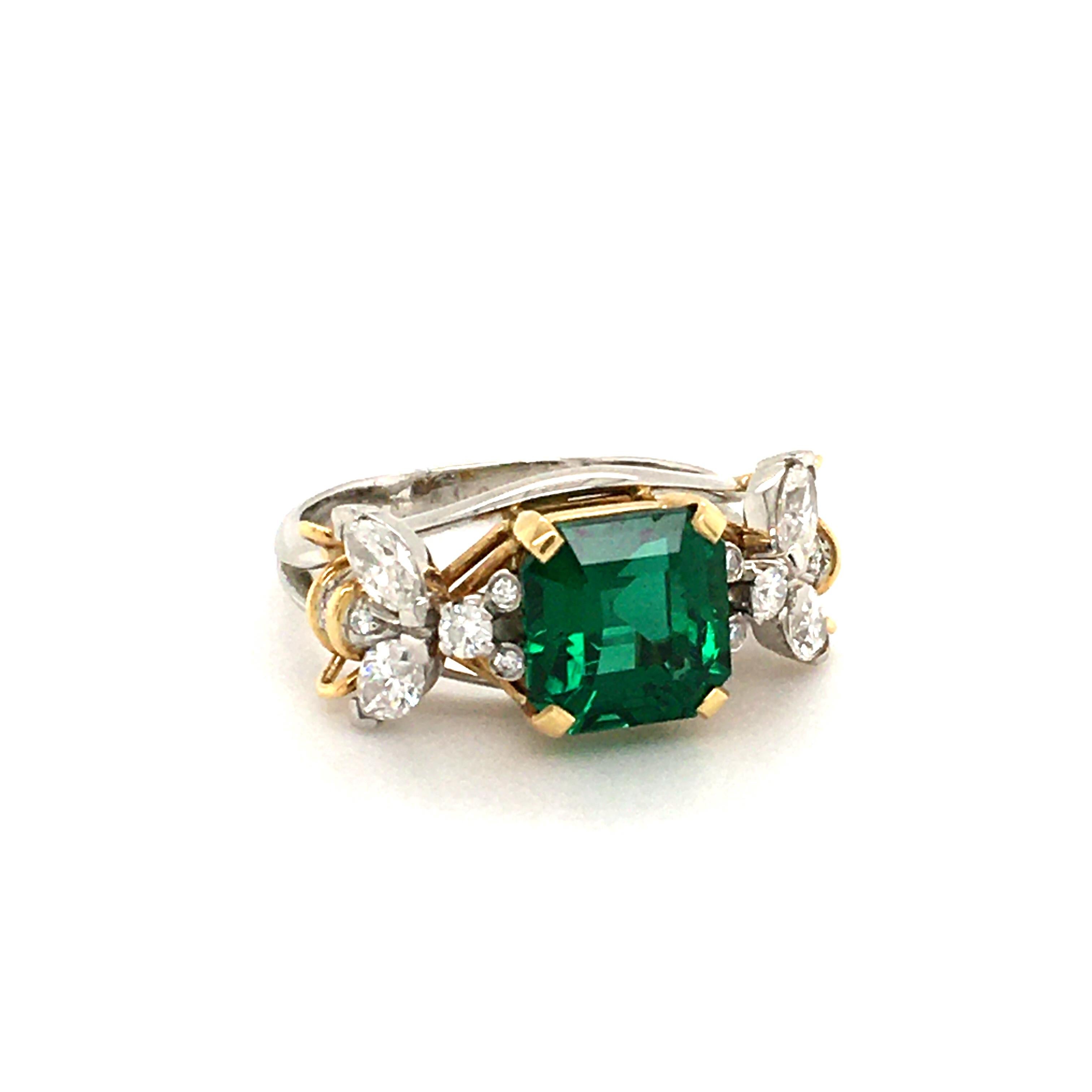 Set with a certified unenhanced octagonal-cut emerald weighing 3.26 carats. Flanked on either side by sculpted circular and marquise-cut diamond bees, each with polished gold wire details. Mounted in platinum and 18k gold

Accompanied by SSEF