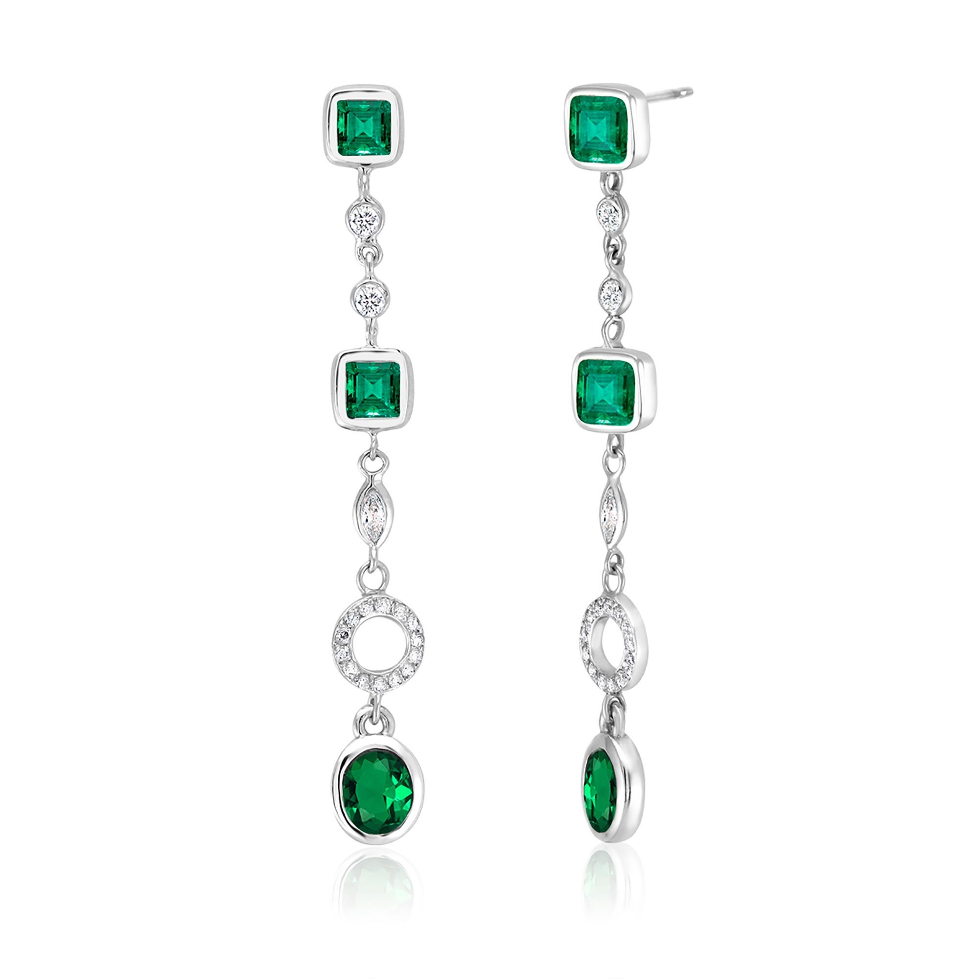 Fourteen karat white gold two inch drop earrings 
Diamond weighing 0.70 carat
Marquise diamond weighing 0.40
Emeralds weighing 2.80 carat 
New Earrings
One of a kind earrings 
Handmade in USA
The 14 karat gold earrings are hanging off a post with