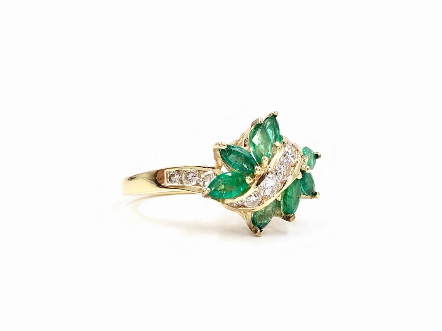 Circa 1970. This beautiful and understated spray style ring features approximately 1.30 carats of genuine well saturated marquise cut emeralds and approximately .60 carats of round brilliant diamonds, set in 14 karat yellow gold. Diamond quality is