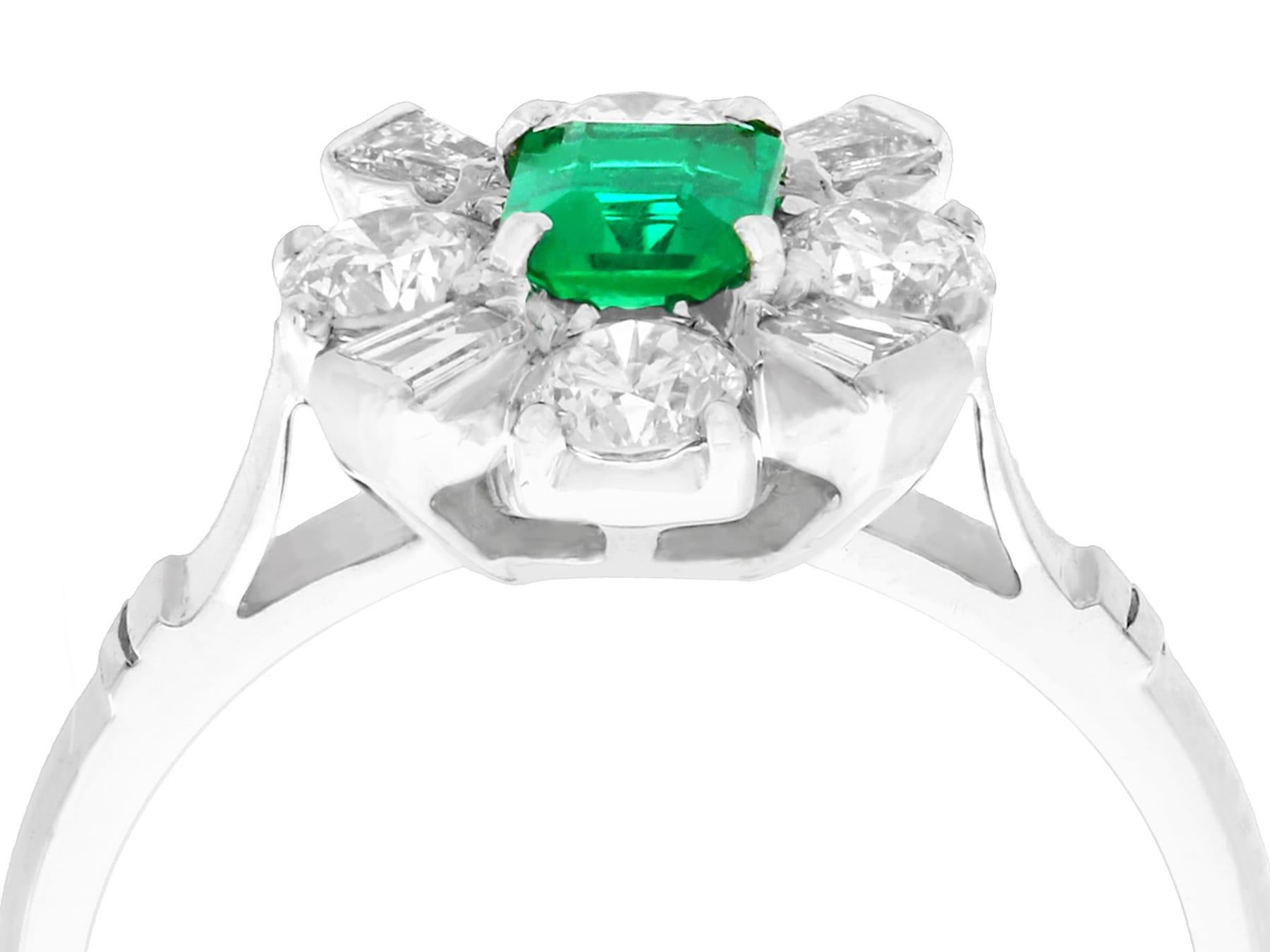 An exceptional, fine and impressive contemporary 0.38 carat natural emerald and 0.54 carat diamond, 18 karat white gold cluster ring; part of our contemporary jewelry and estate jewelry collections.

This exceptional contemporary emerald cluster