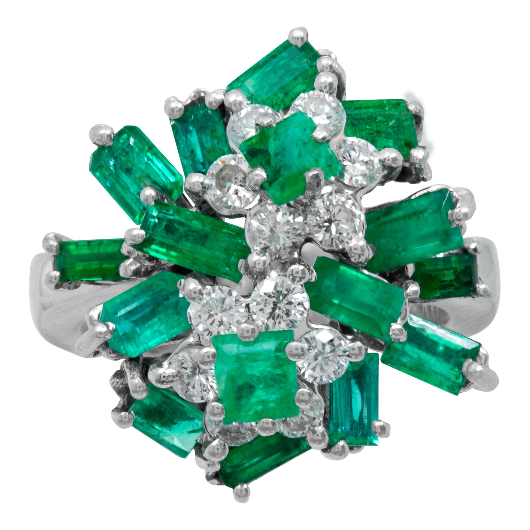Emerald and diamond cocktail Ballerina ring in 18K white gold with approximately 2 carats in princess and baguette cut Emeralds and 0.5 carats in round brilliant cut diamonds (G Color, SI Clarity). Size 5.5. measures 20mm x 20mm.

This