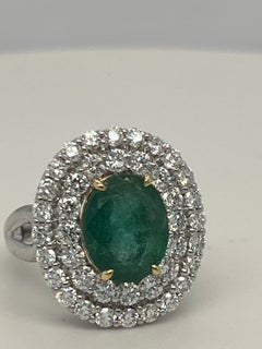 1.65 Carat Oval Cut Emerald and Diamond Halo Ring
