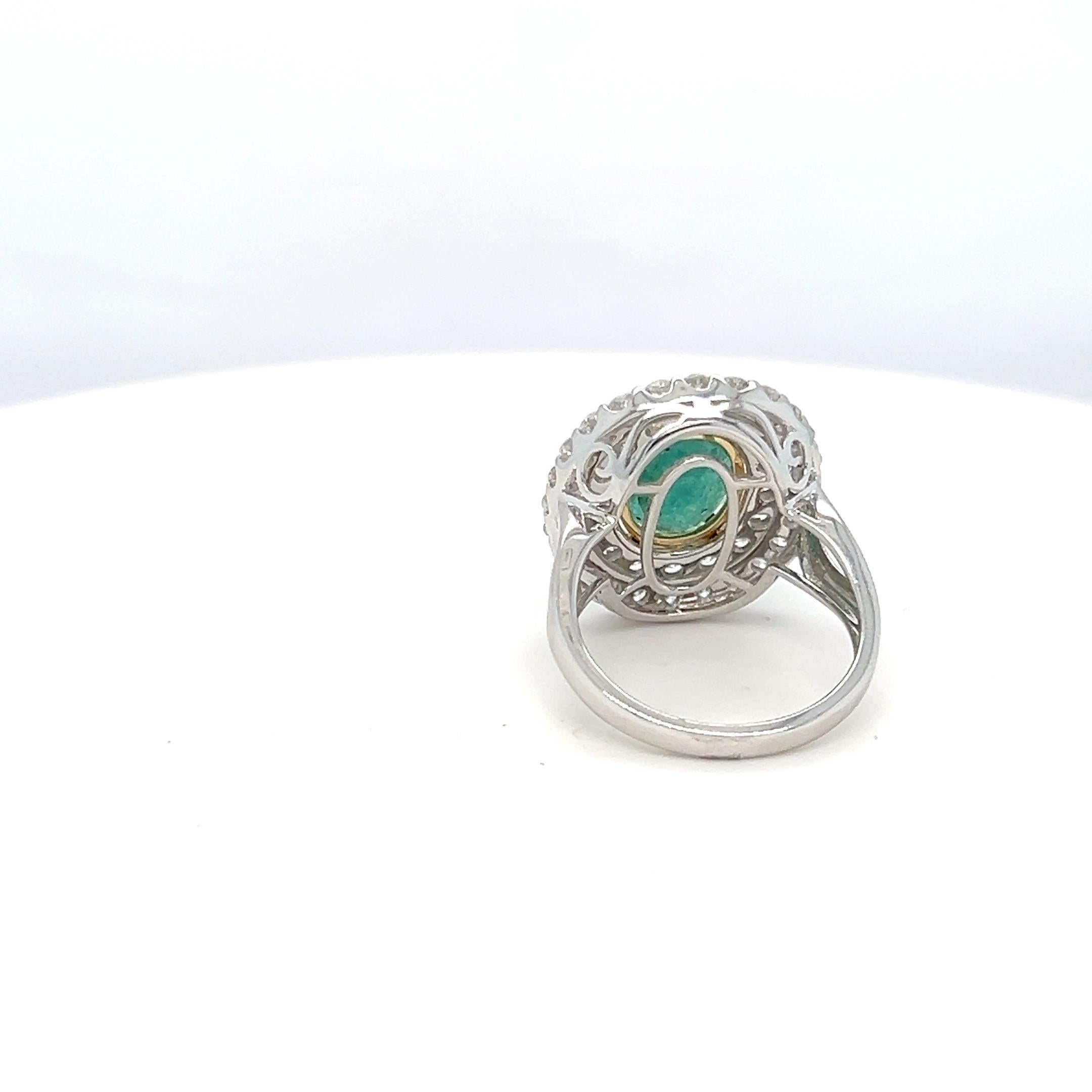 1.65 Carat Oval Cut Emerald and Diamond Halo Ring In New Condition For Sale In Trumbull, CT