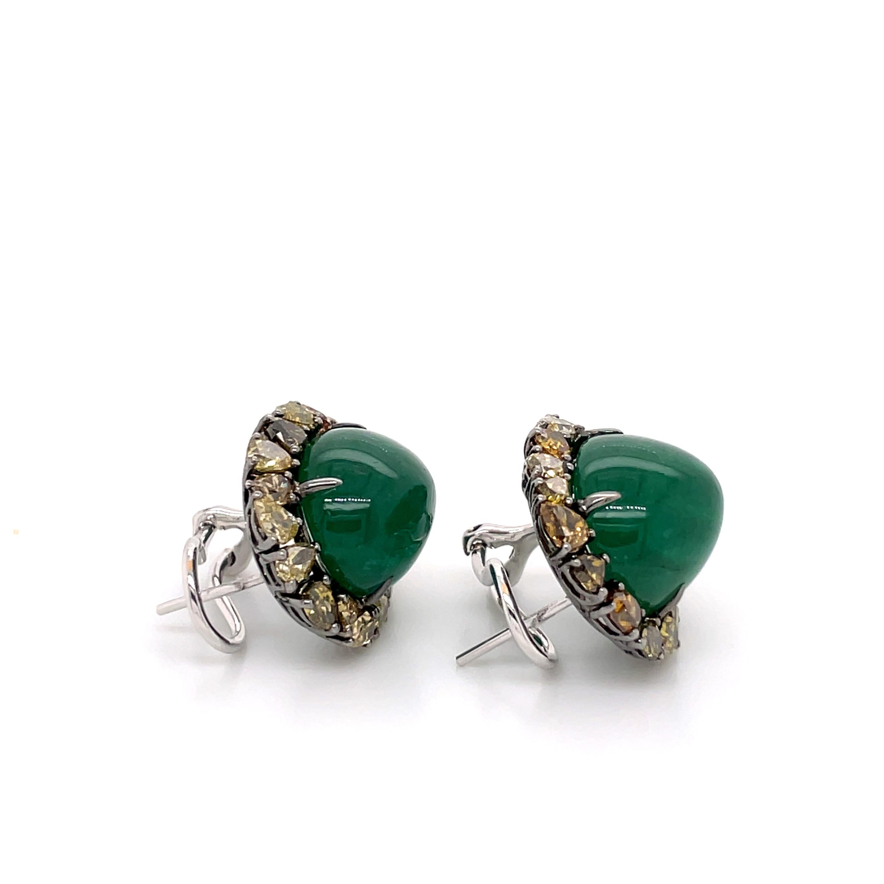 The Emerald and Fancy Diamond Stud Cocktail Earrings are a stunning pair of earrings that exude elegance and sophistication. Crafted with meticulous attention to detail, these earrings feature a combination of vibrant emeralds and dazzling fancy