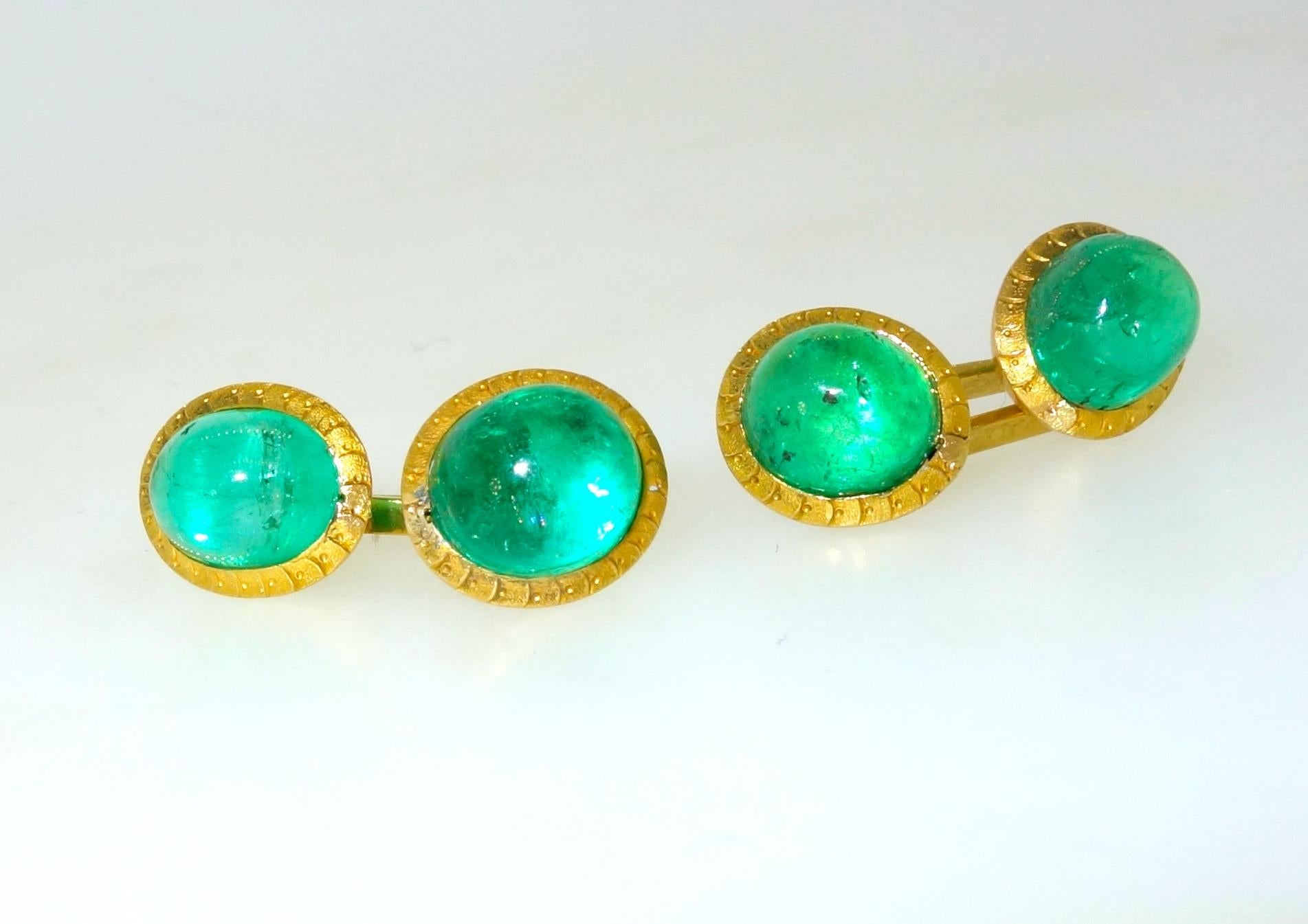 Colombian emeralds weighing approximately 12 cts. totally are set in 18K yellow gold.  These back to back cufflinks were made last quarter of the 19th century.  The high cabochon emeralds are bright and clean and probably from the old Chivor mines