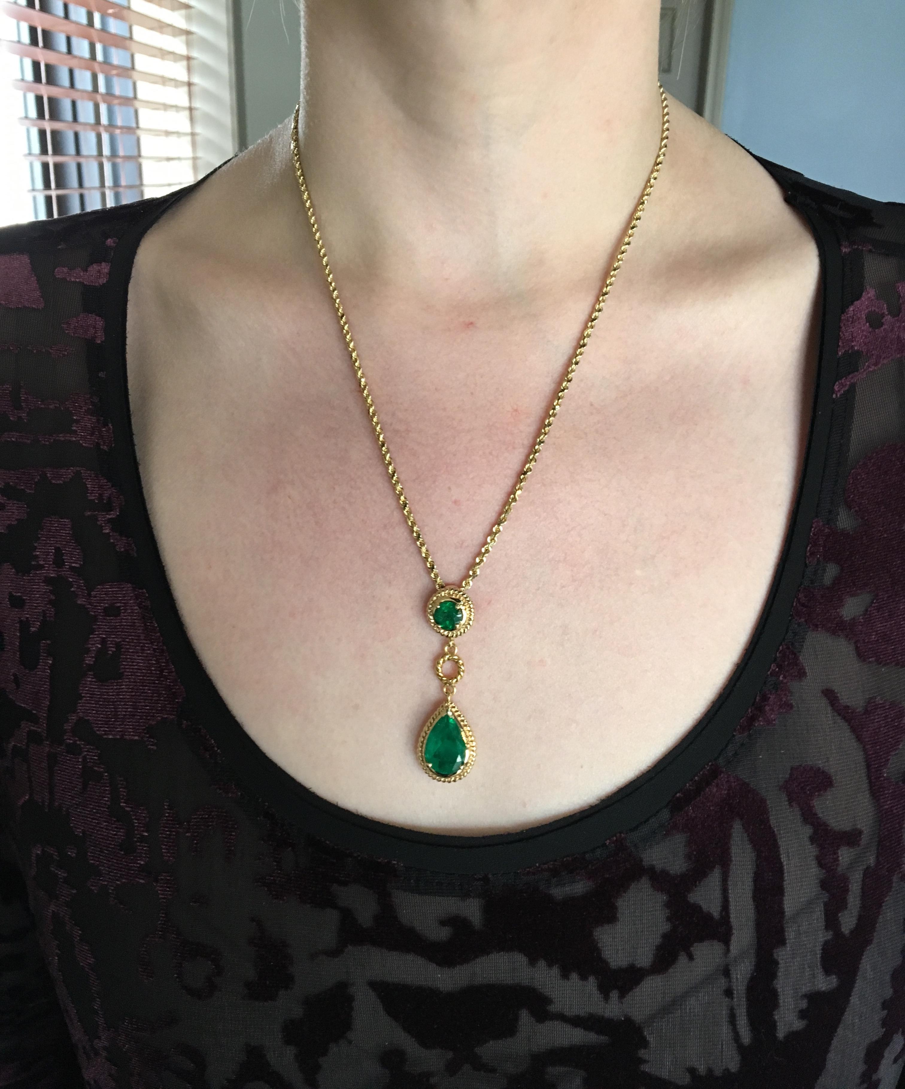 14K Yellow Gold necklace features a two emeralds in a rope like design. The pear cut emerald measures approximately 10.39MM X 14.50MM. The Round emerald measures approximately 7.11MM.  These beautiful emeralds have a vibrant green color.  Like most