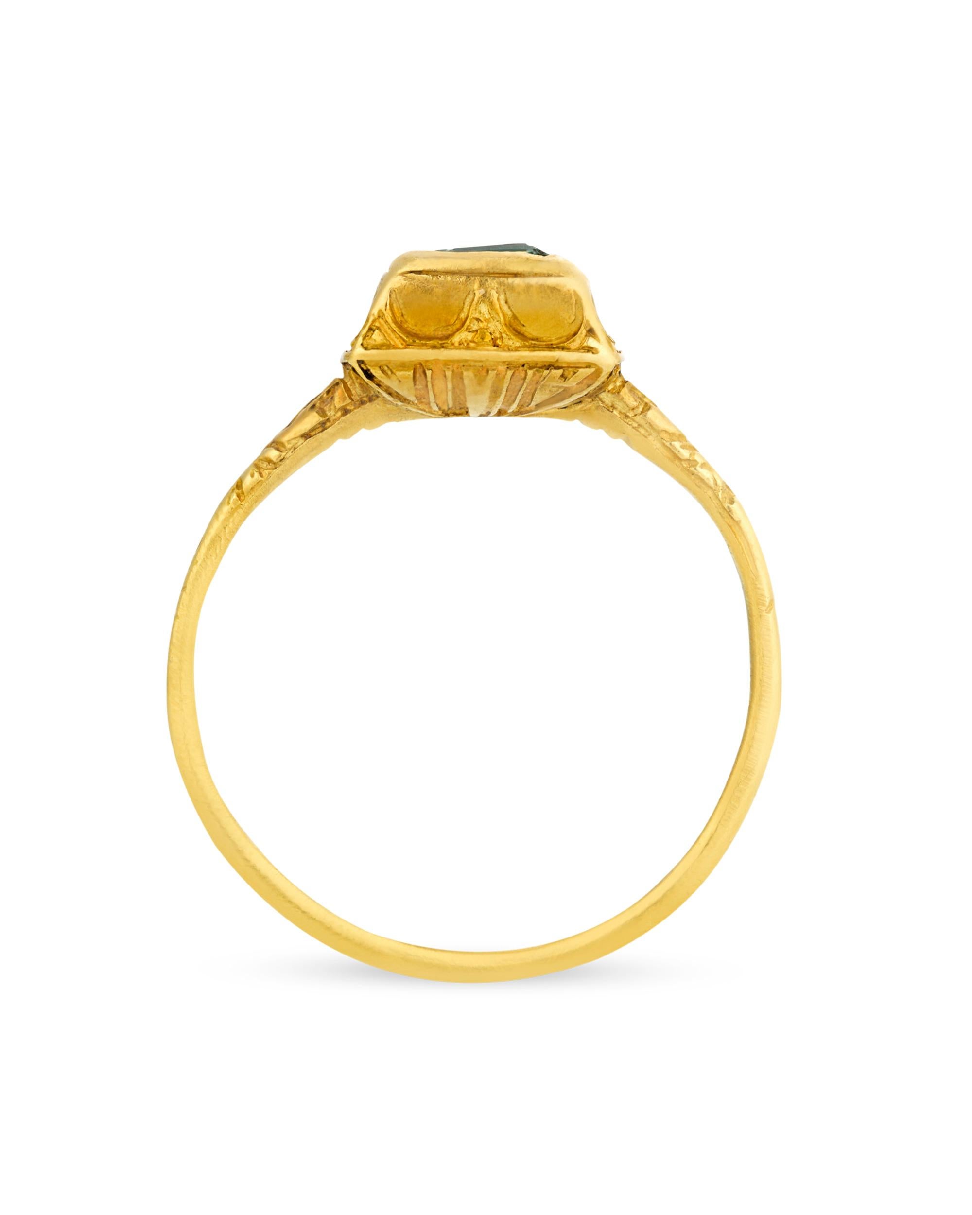 This remarkable emerald and gold ring dates back to the 16th century. Renaissance jewelry artisans incorporated enamel and brighter gemstones than preceding Gothic gemstone jewelry, evidenced here by the vibrant emerald bezel set at the center of