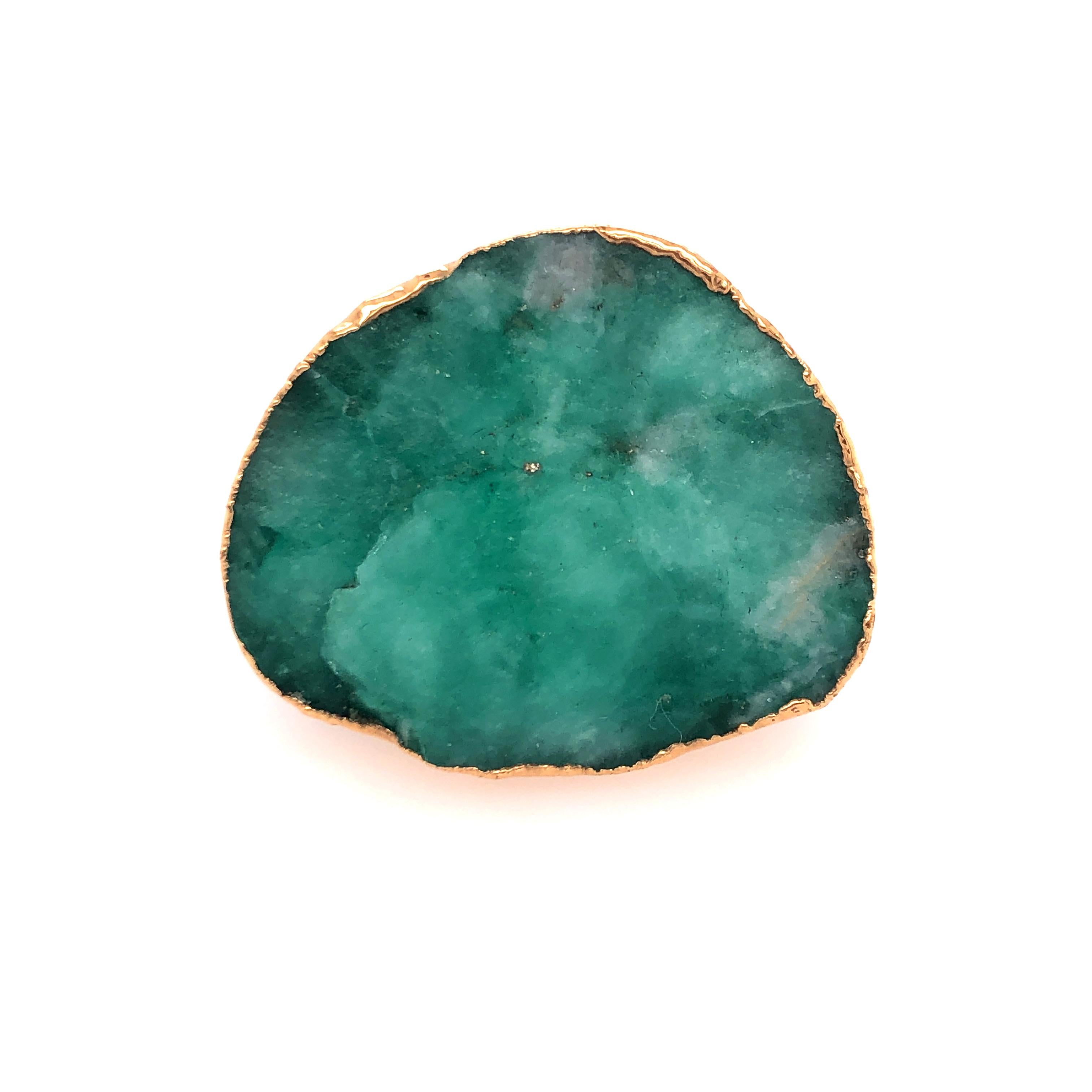 Rarely seen in its rough form, the emerald in this ring portrays the wide spectrum of values that dance as if in a sea of green. It is set on top of Horn and wrapped in gold accent. 

Size: 