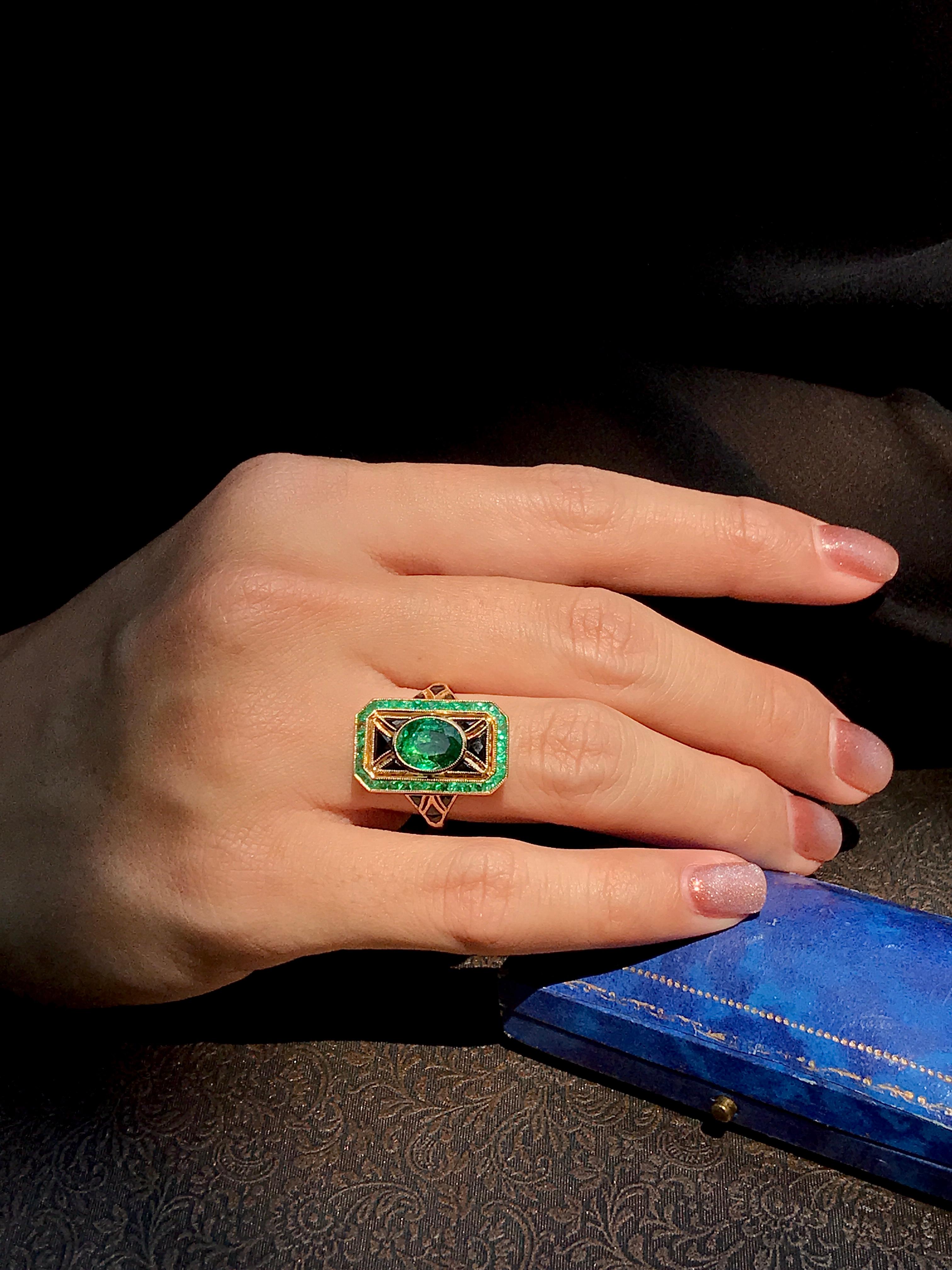 An Art Deco inspired cocktail ring featuring a 1.33 carat oval cut vibrant green emerald in bezel set, surrounded by French cut onyx and emerald. Crafted in 18k yellow gold, the ring is amazingly unique.

Ring Information
Style: Art-deco
Metal: 18K