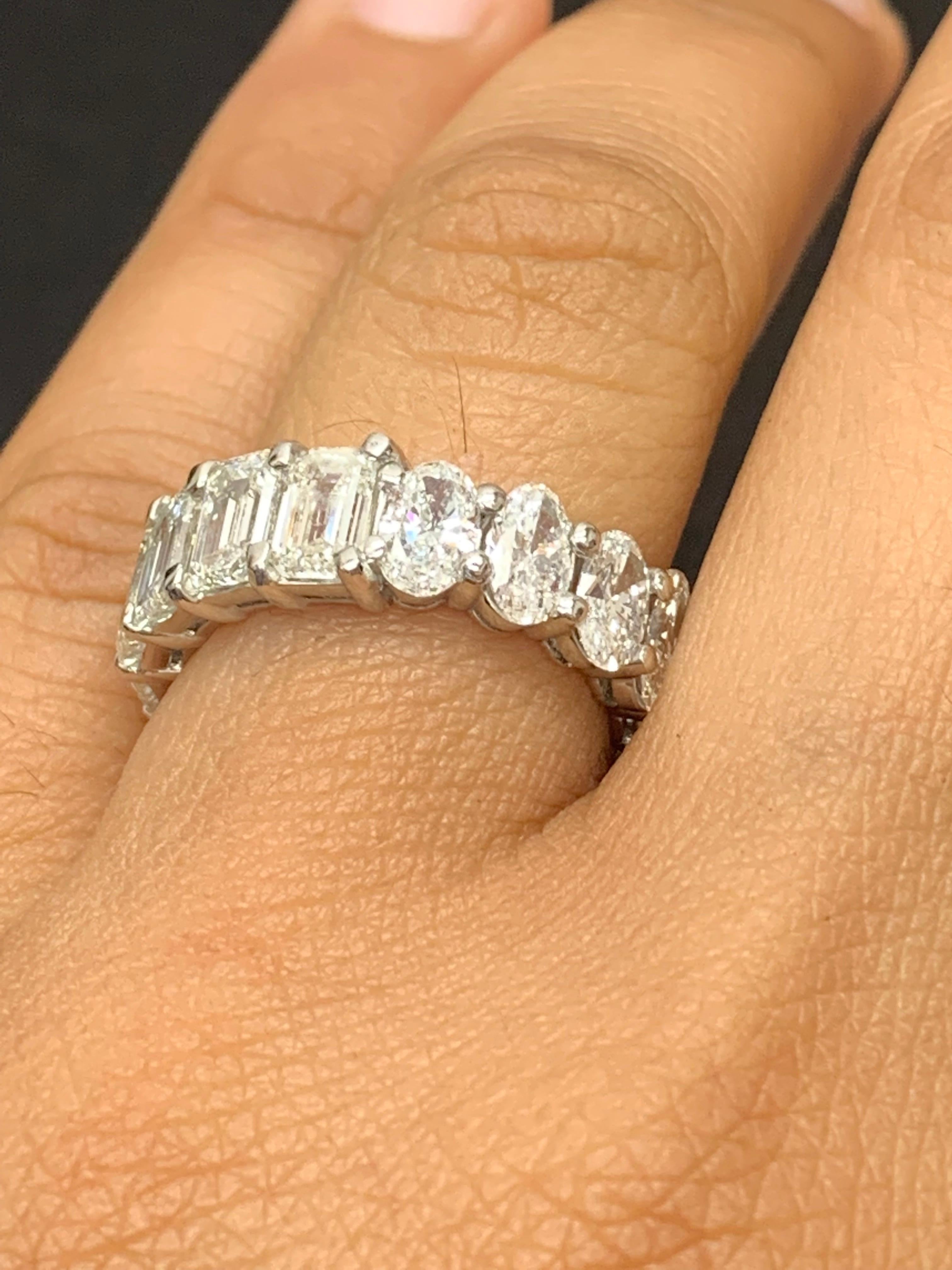 A classic and timeless eternity band style showcasing a row of half emerald cut and half oval cut diamonds set in a shared prong platinum mounting. 9 emerald cut Diamonds weigh 4.66 carats and 8 oval cut diamonds weighing 2.67 carats. Can be