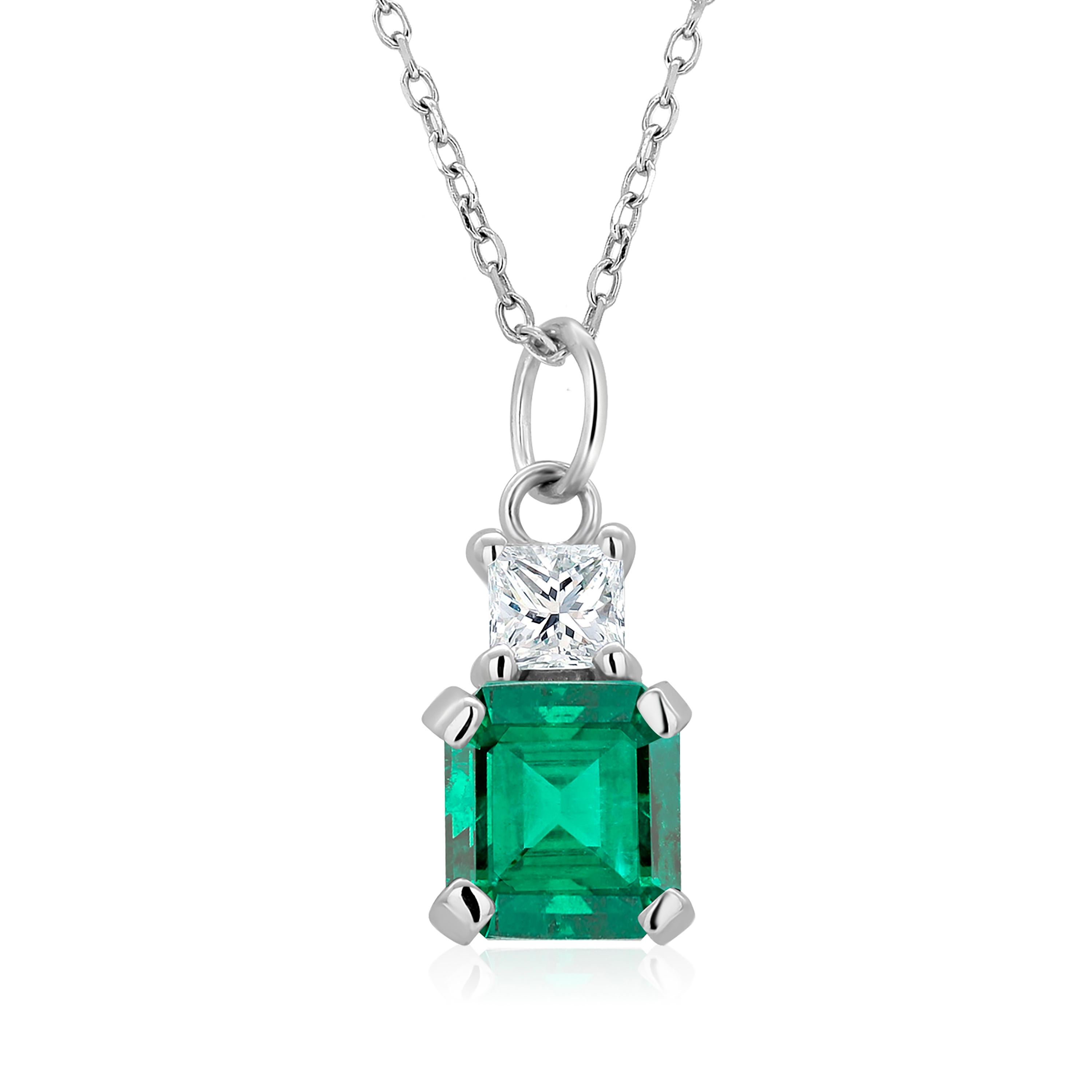 14 karats white gold necklace pendant with emerald-shaped emerald
Necklace measuring 16 inches long
Colombia emerald-cut emerald  weighing 0.85 carats
One princess cut diamond weighing 0.15 carats
Emerald color hue is grass green
Cable chain