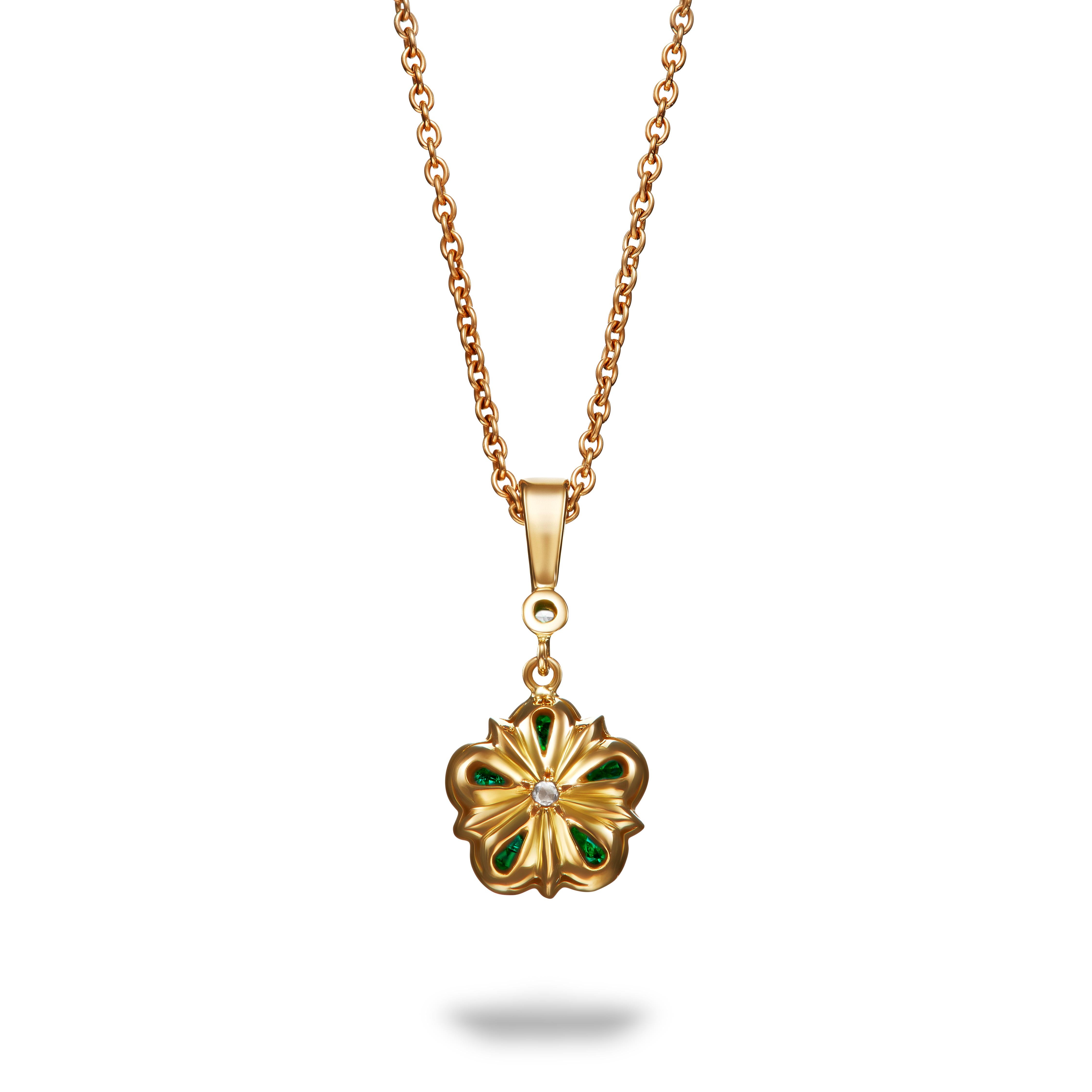 This unique emerald and rose cut diamond Rose pendant features vibrant emeralds surrounding a scintillating rose cut diamond. The pendant is suspended from an 18k yellow gold bail with another lovely matching rose cut diamond. In true Aril Jewels