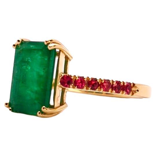 This elegant ring is centered with an intense green Emerald that weighs ct 3.39.
The central stone is accentuated by brilliant cut Rubies that weighs ct 0.33.
The combination of green and red create a very intense and deep color effect. This ring is