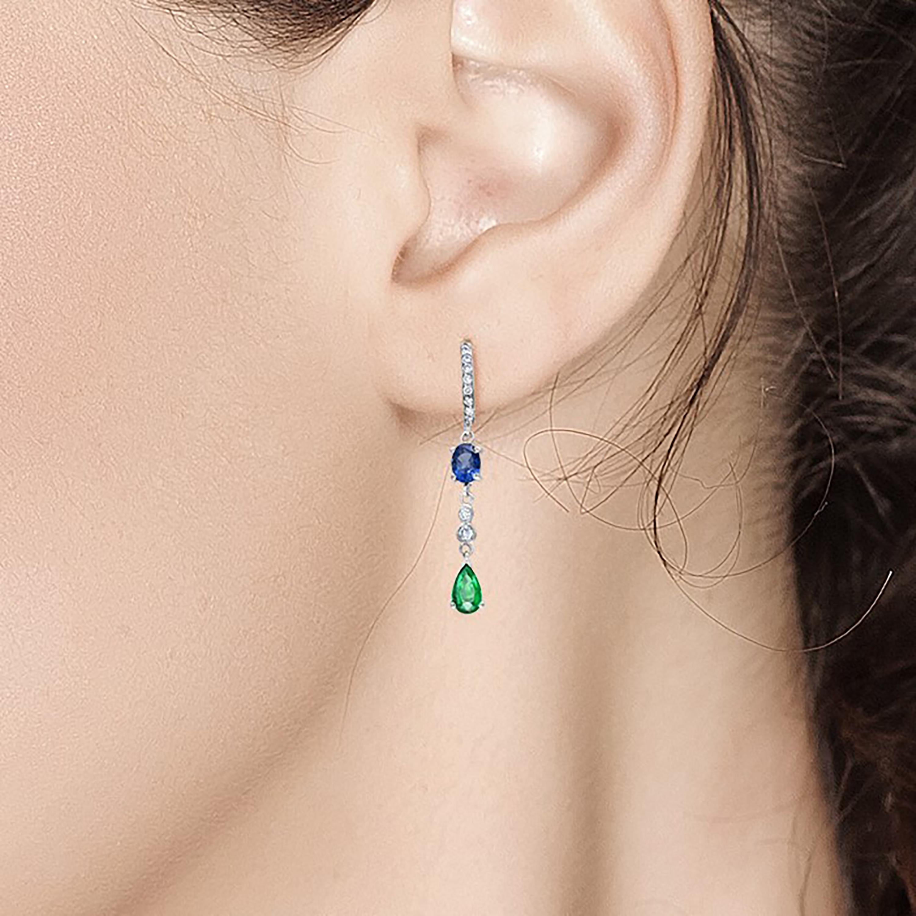 Fourteen karats white gold diamond hoop earrings 
Matched and mirrored emerald and sapphires in a shoulder dusty pendant earrings 
Pear Shape and oval shape Sapphire weighing 1.20 carat 
Pear shape and oval emerald weighing 1.00 carat
Diamond hoops
