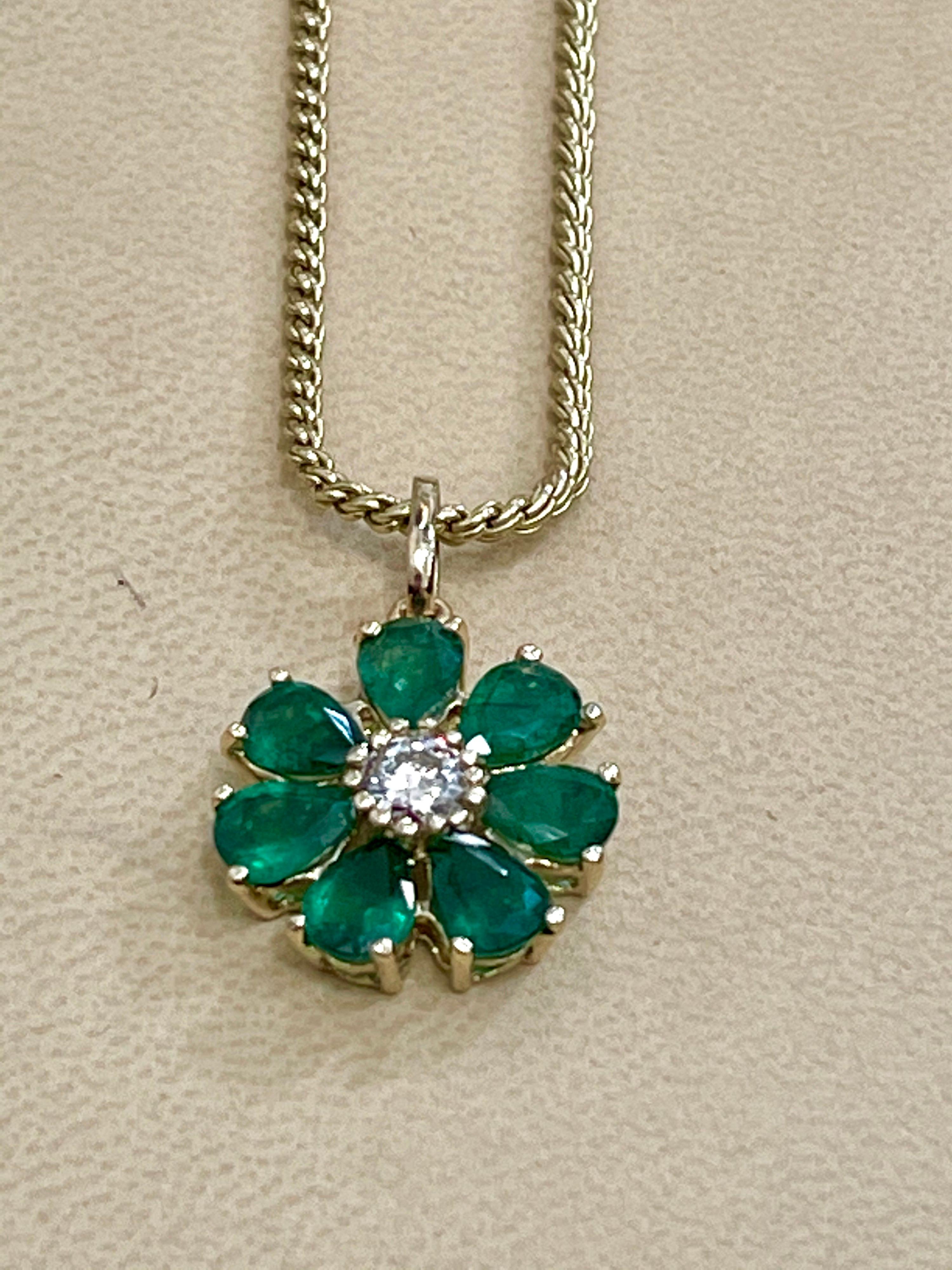 
Emerald and Solitaire Diamonds Flower Pendant Necklace 14 Karat Yellow Gold Chain 
App0roximately  5 Carat  Round Cut Emerald  and 0.40  ct  solitaire diamond flower pendant 

This exquisite Pendant is beautifully crafted with 14 karat  Yellow gold