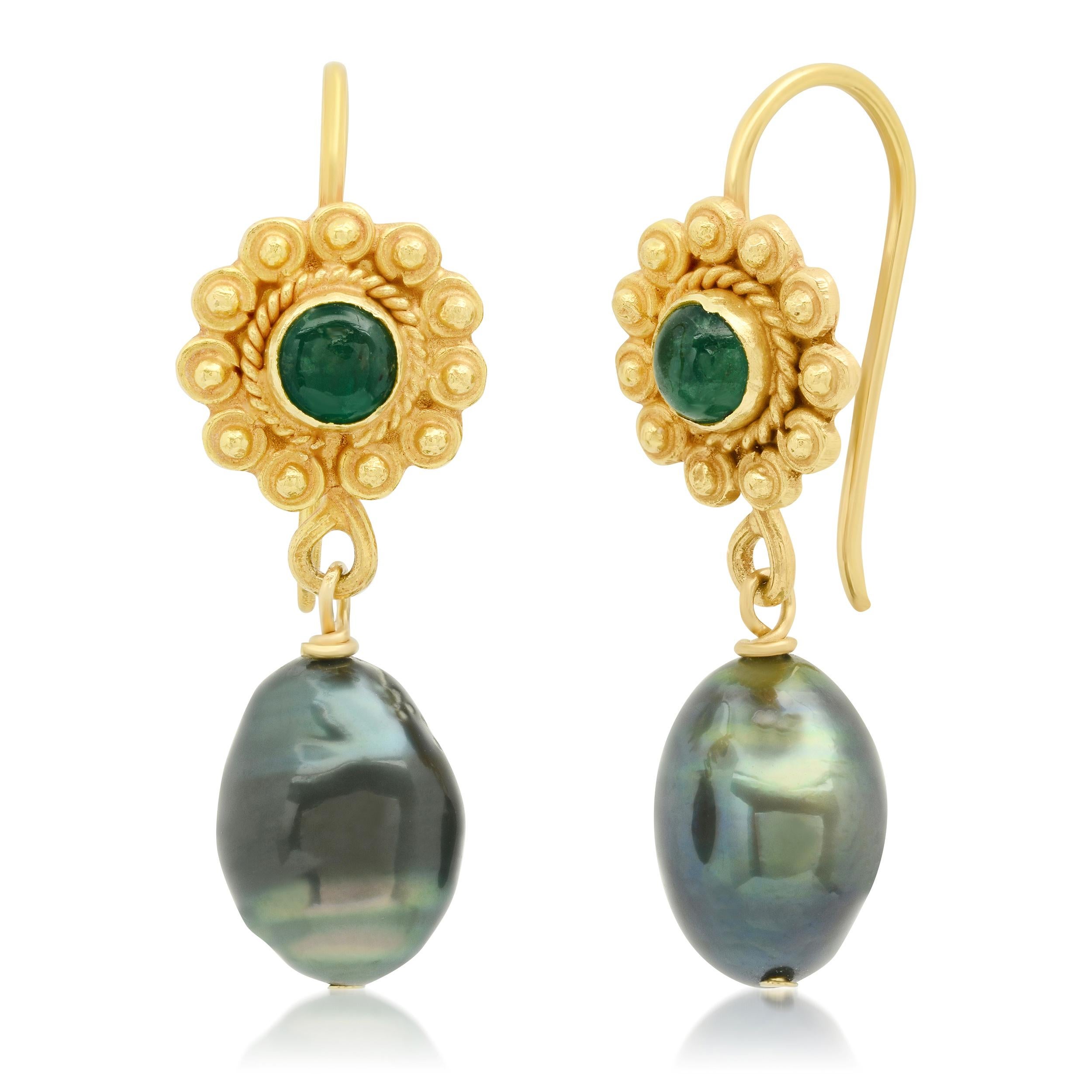 Set in rich 18k yellow gold with elegantly designed posts framing two perfectly matched Emerald Cabochons.  Completing the design are 2 black Tahitian Keshi pearls with a hint of a green hue to compliment the emeralds and suspended to give just the