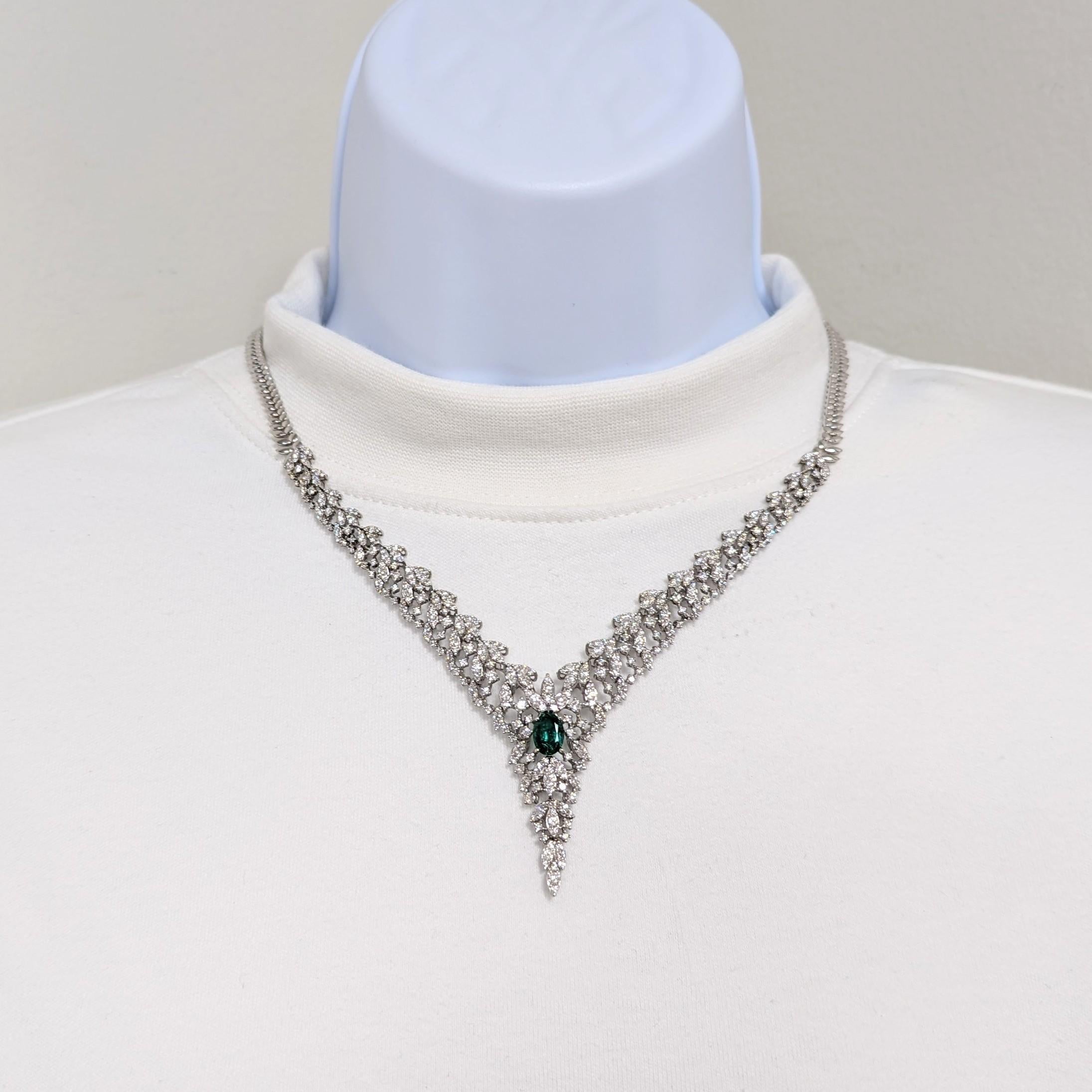 Beautiful cluster style necklace a with 1.86 ct. emerald oval and 7.50 ct. of good quality, white, and bright diamond rounds and marquise shapes.  Handmade in 14k white gold.  Length is 16