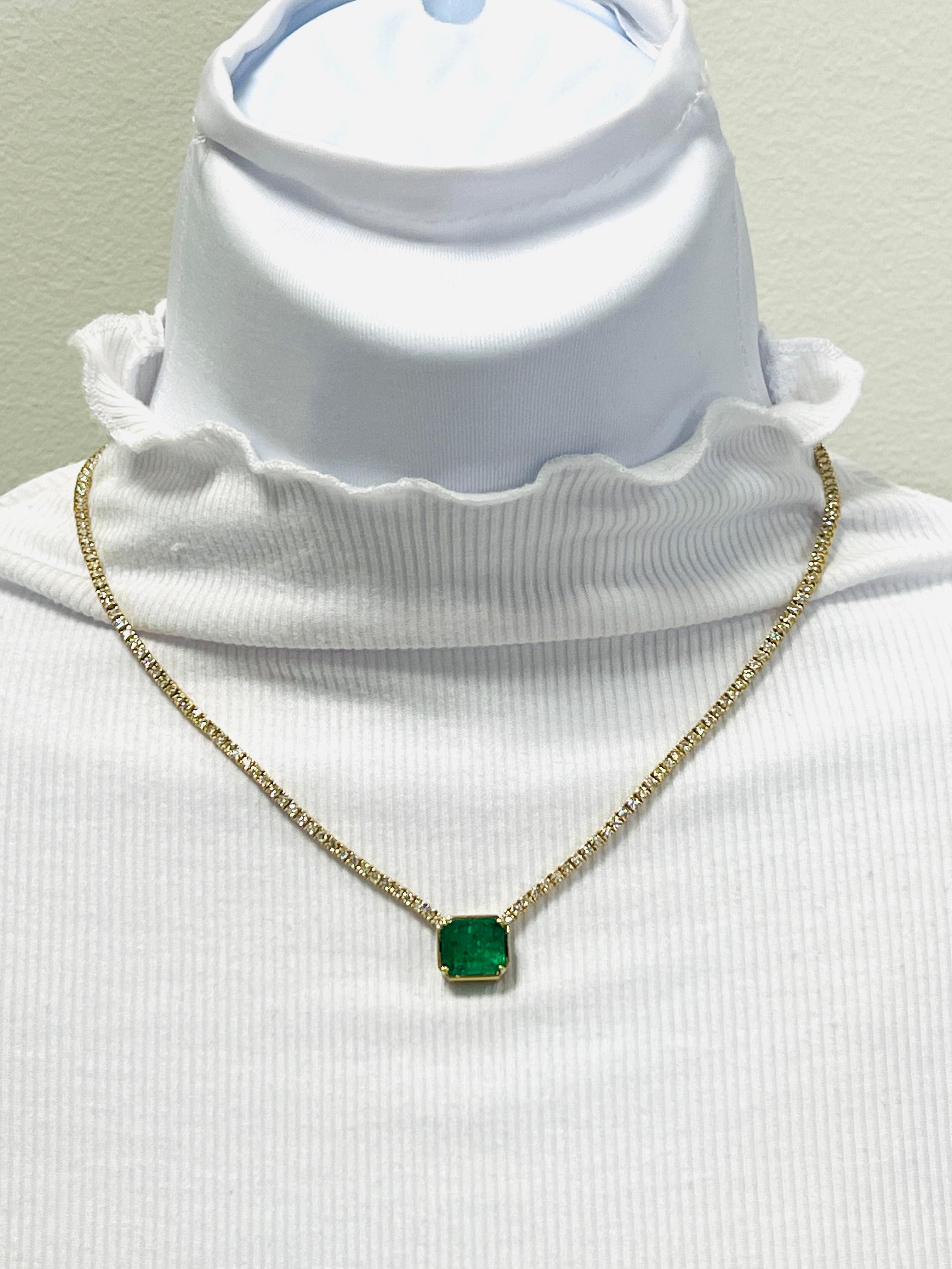 Beautiful 4.85 ct. bright green emerald emerald cut with 5.58 ct. good quality white diamond rounds.  Handmade in 14k yellow gold.  Length is 16