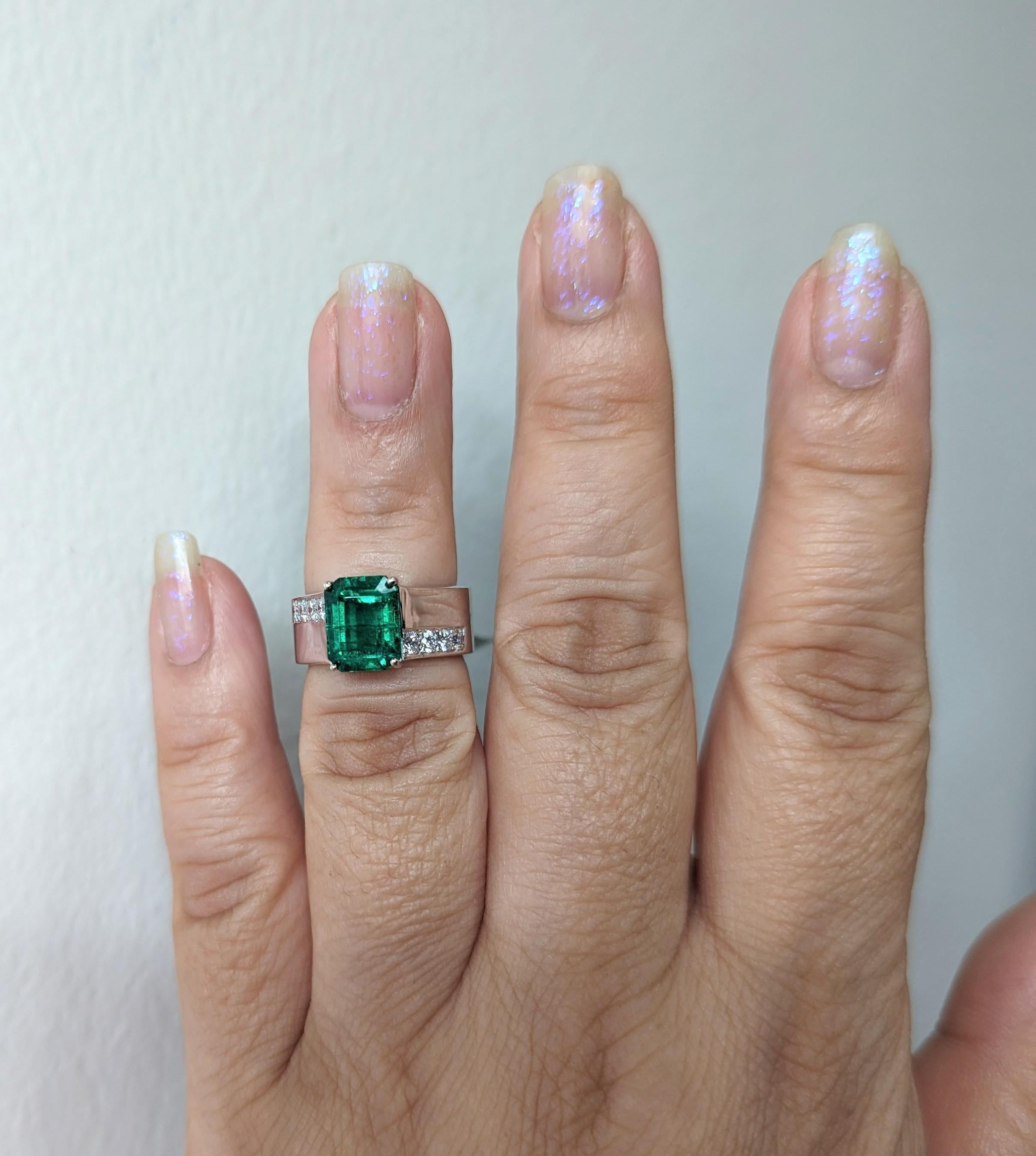 Beautiful 3.55 ct. emerald emerald cut with good quality white diamond rounds.  Handmade in 14k white gold.  Ring size 6.25.