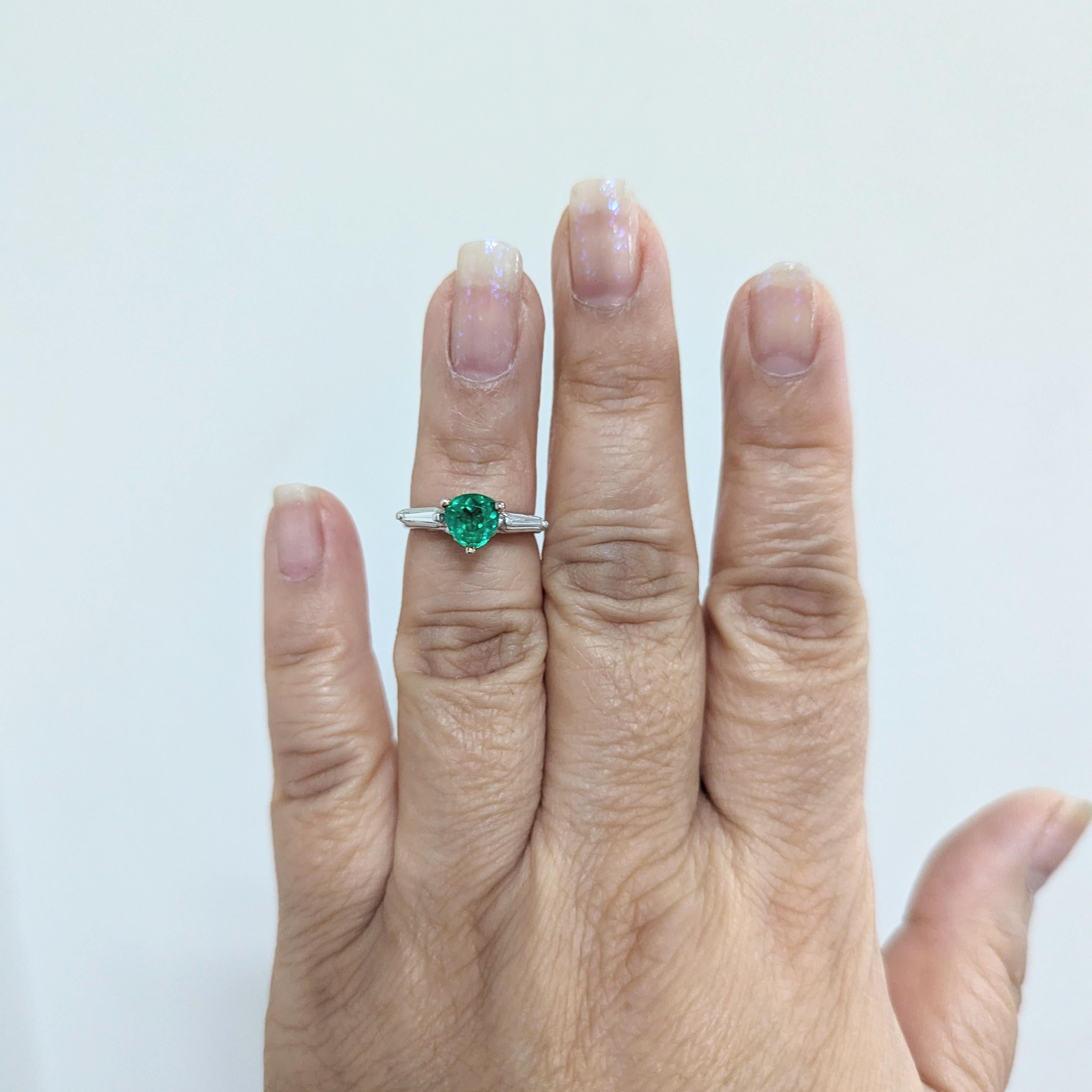 Beautiful ring that can be worn in two different ways.  Emerald pear shape that weighs 1.01 ct. with 0.50 ct. good quality white diamond rounds and baguettes.  Handmade in 14k white gold and platinum.  Ring size 5.25.  Ring can be worn with just the
