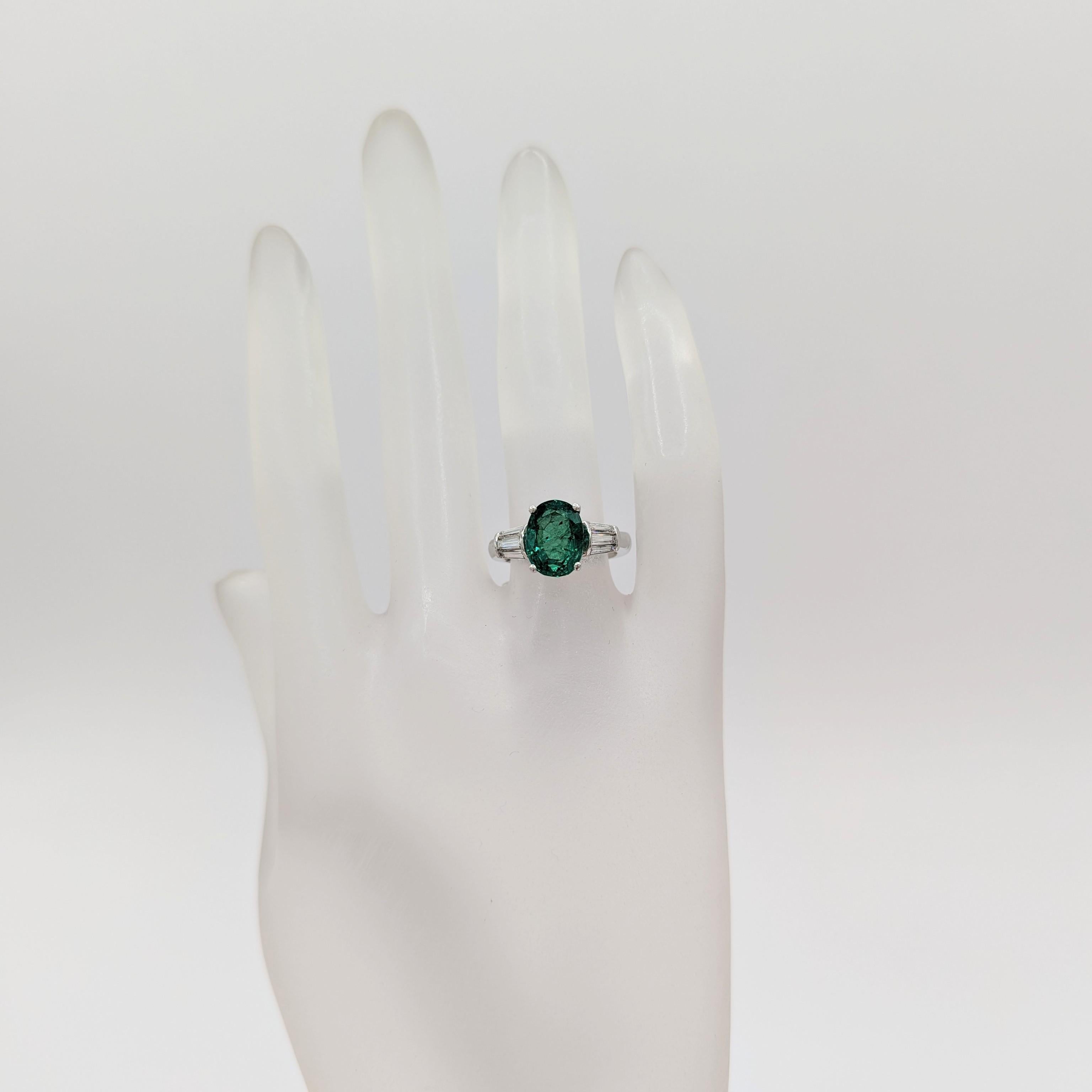 Oval Cut Emerald and White Diamond Three Stone Ring in 18K White Gold For Sale