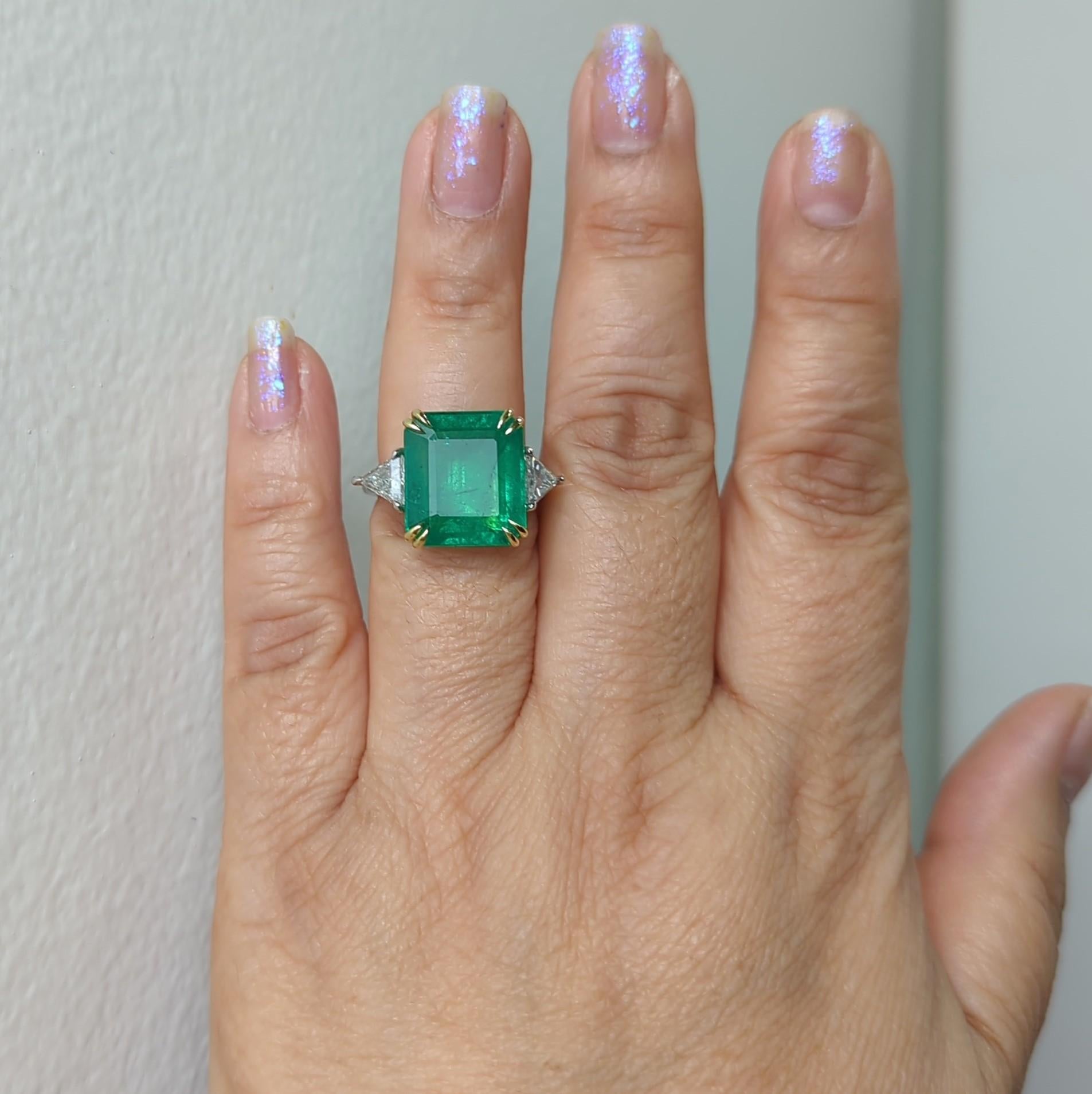 Gorgeous 11.90 ct. emerald emerald cut with 1.02 ct. good quality, white, and bright diamond trillions.  Handmade in platinum and 18k yellow gold.  Ring size 6.5.