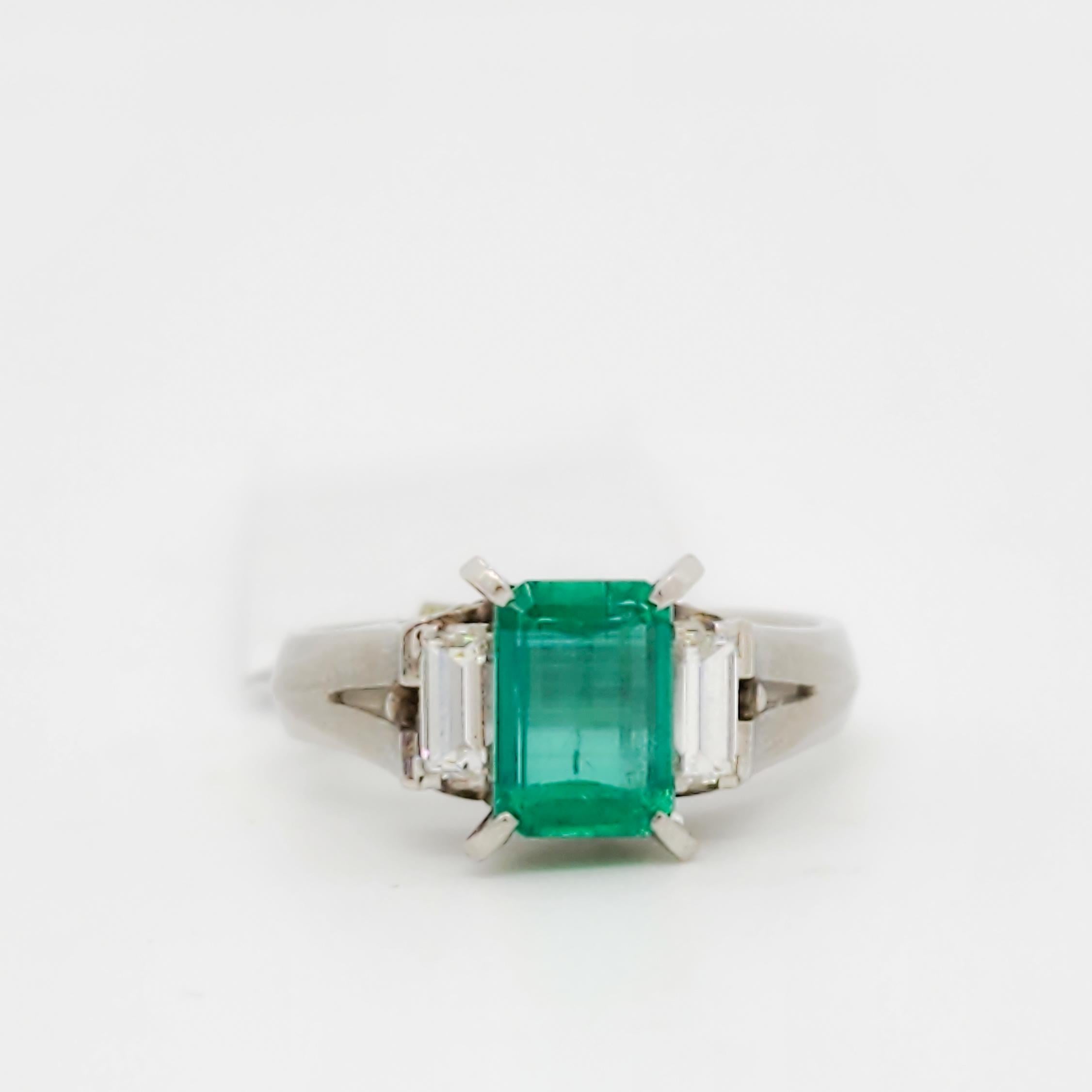 Emerald Cut Emerald and White Diamond Three Stone Ring in Platinum