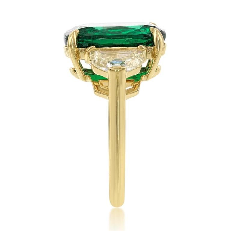 EMERALD AND YELLOW DIAMOND RING A vibrant cushion cut Emerald is offset by two Fancy Intense Yellow half moon diamonds. Only the finest combination of warmth and elegance Item: # 02438 Metal: 18k Y Lab: C.dunaigre Color Weight: 6.31 ct. Diamond