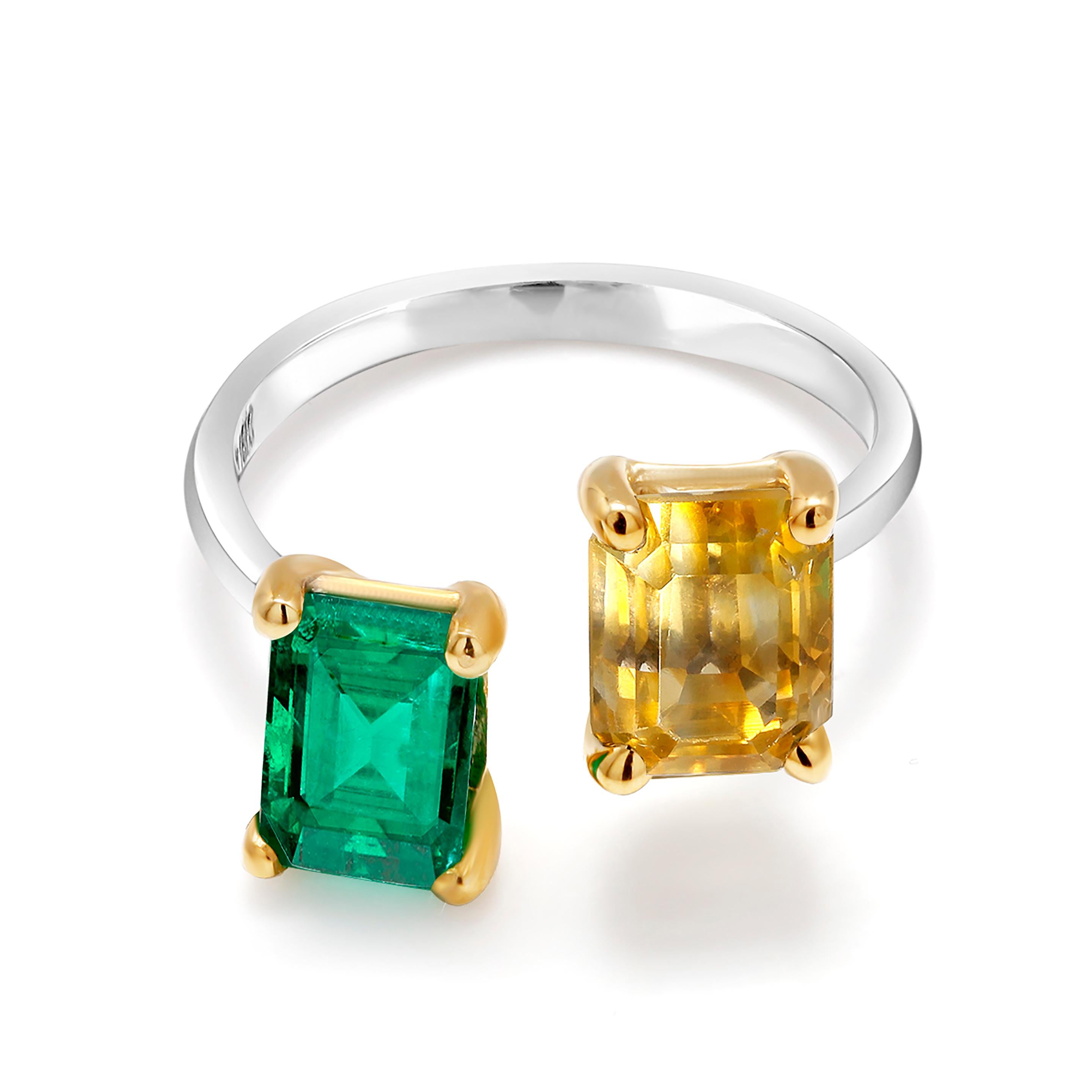 Open band with facing emerald cut emerald and emerald cut yellow sapphire
Eighteen karat white and yellow gold ring
Emerald cut emerald weighing 1.25 carat  
Emerald cut yellow sapphire weighing 2.86 carat                                            