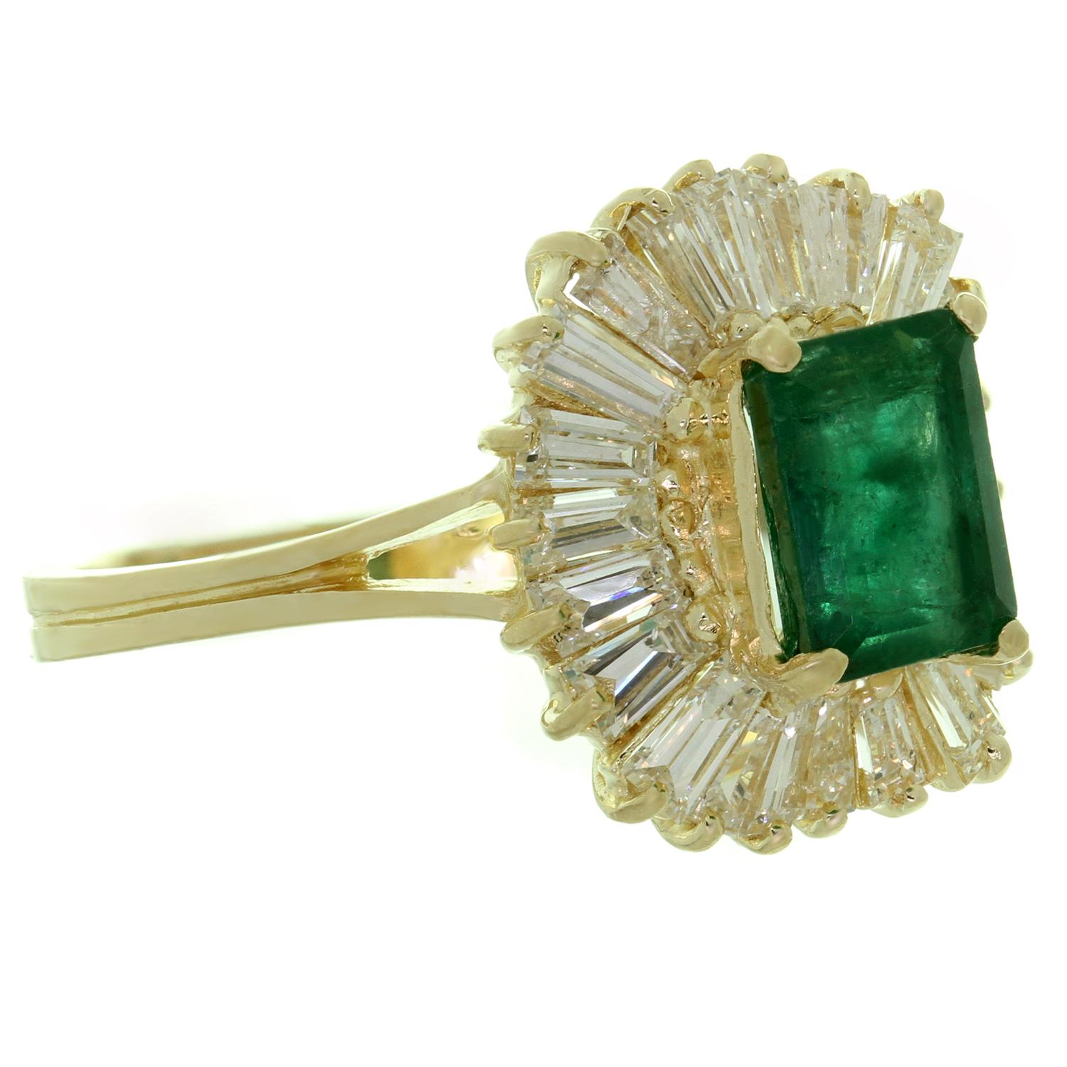 This classic estate ballerina cocktail ring is crafted in 14k yellow gold and set with with a genuine emerald-cut green emerald approximately 1.50 carat,  in suturated deep green color surrounded with baguette-cut diamonds weighing an estimated 1.55