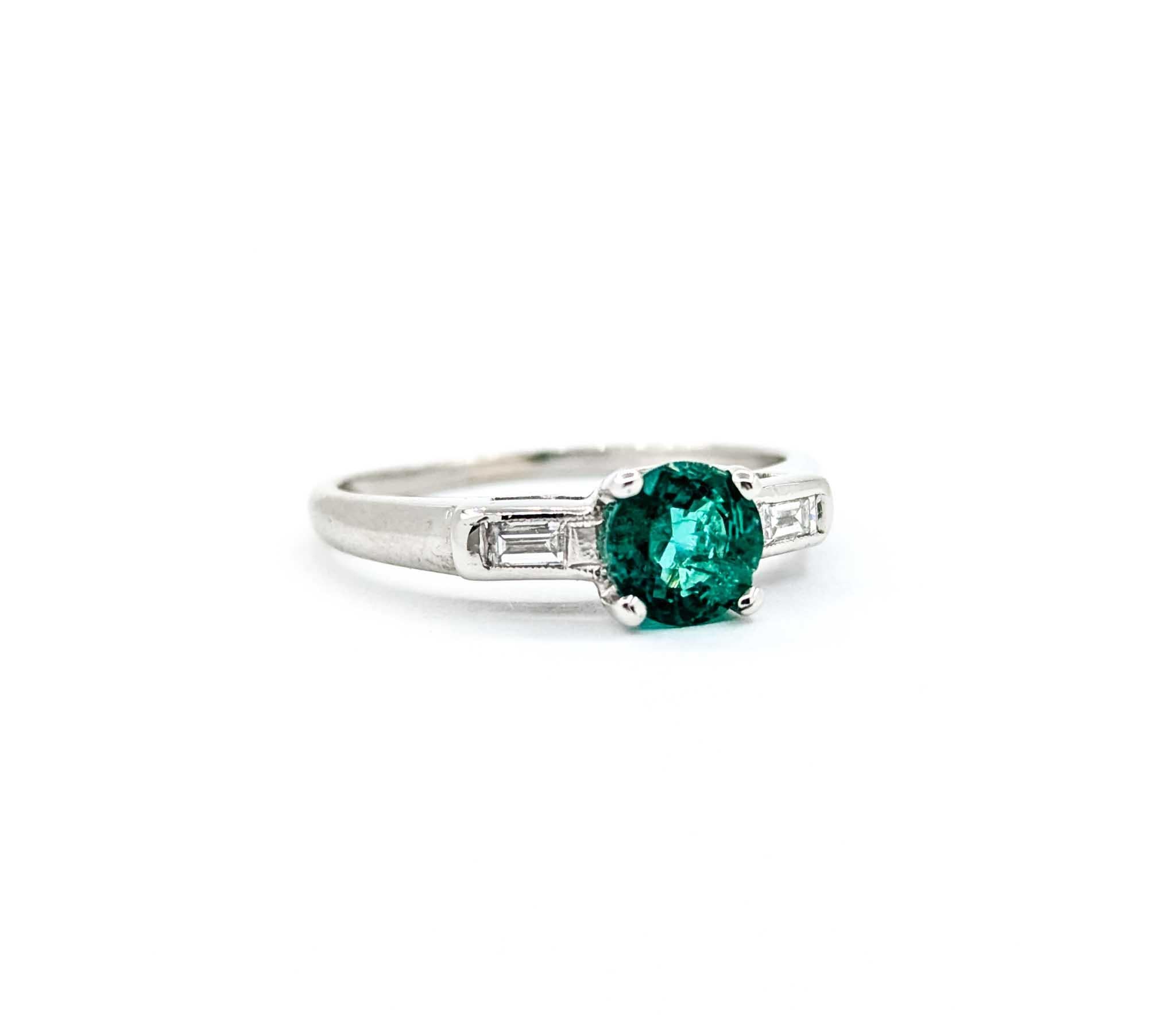 Elegant Emerald & Baguette Diamonds Ring in Platinum

Introducing this beautiful emerald & diamond ring, crafted in 900pt platinum. The ring features a stunning .71ct emerald centerpiece with .08ctw baguette diamonds and vintage gems. The sparkly