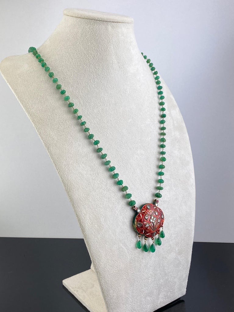 A beautiful 207 carat Emerald Beads and Drops necklace, with a Gold and Silver pendant with intricate enamel work and Diamonds, giving it a very antique look The necklace is currently 27 inches long (not including the pendant) and can be altered.