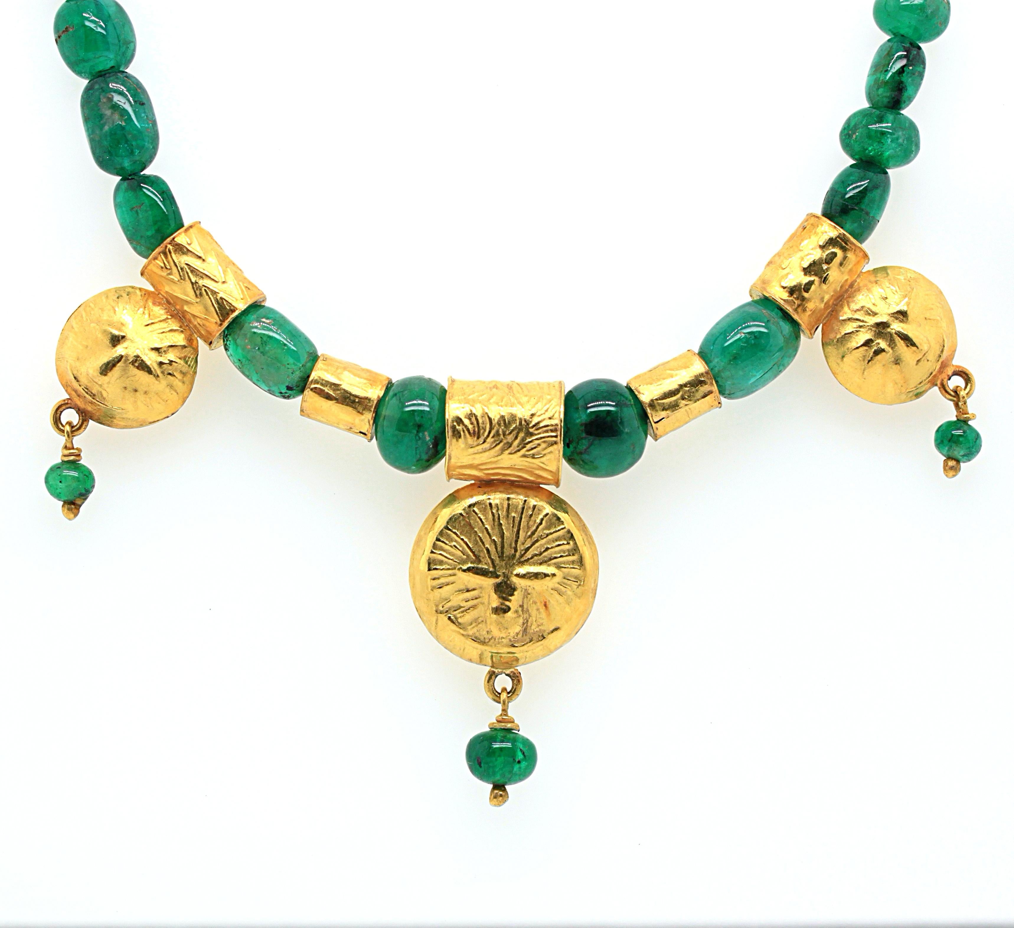 An emerald bead and 18k yellow gold necklace by Atelier Dix. The old mine emeralds have a beautiful strong green colour and are round and oval shaped beads, weighing approximately 90 carats in total. The necklace centre features five golden parts